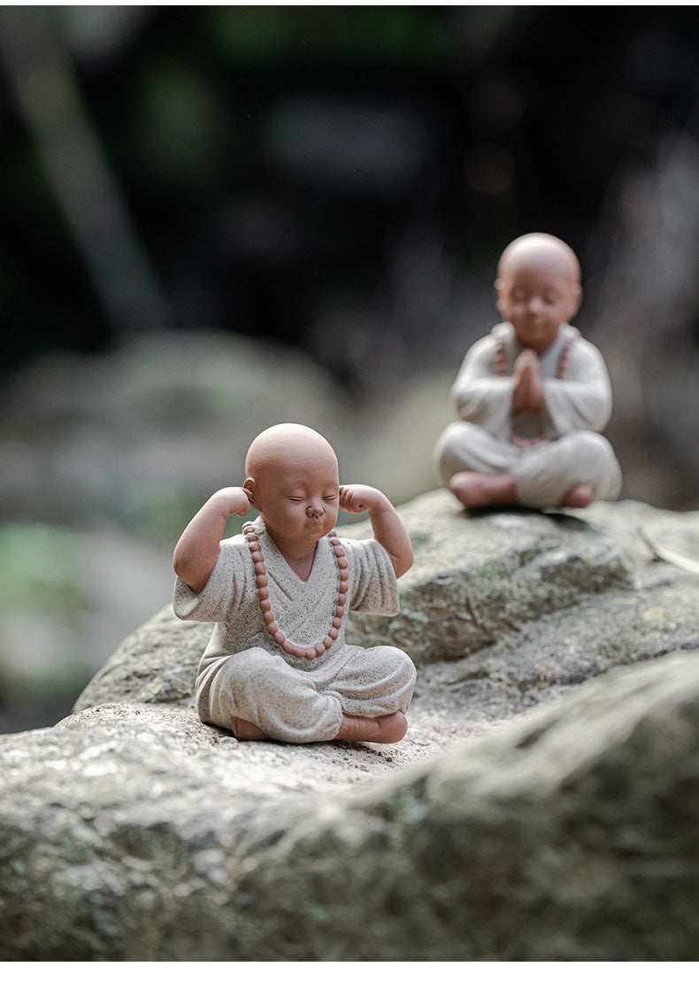 this is a mini pottery monk sculpture