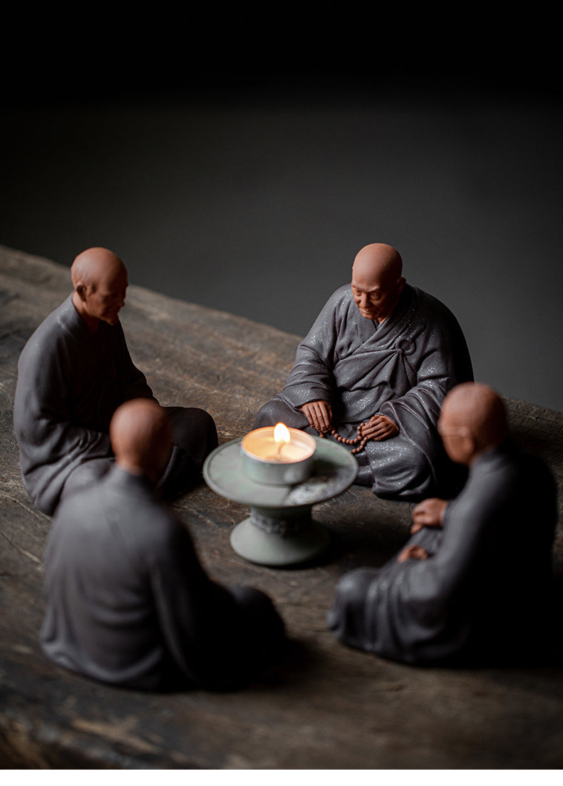 this is a mini pottery monk sculpture