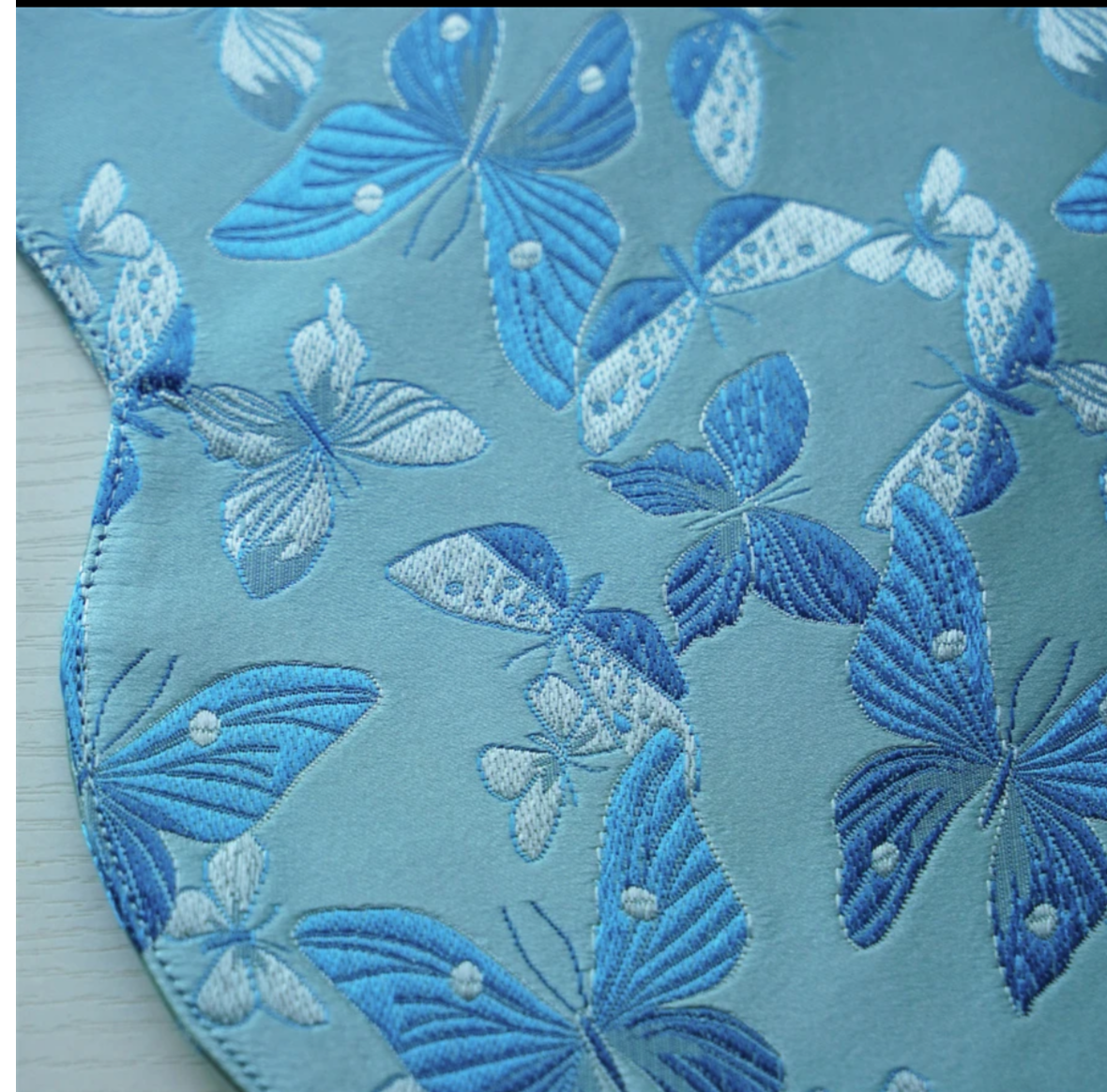 This is a silk brocade butterfly tea mat.this is a waterproof table cloth