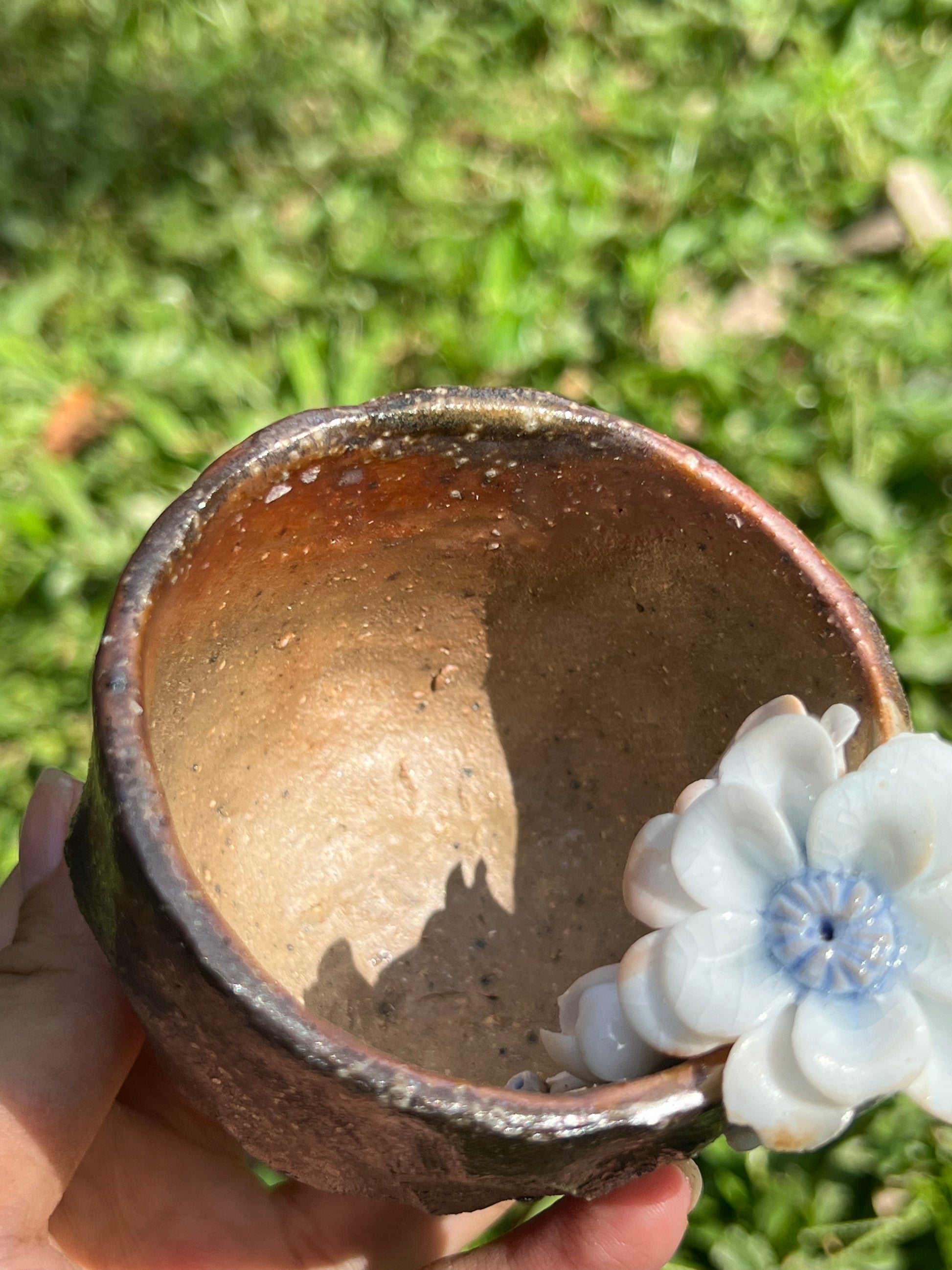 This is a woodfired pottery flower teacup