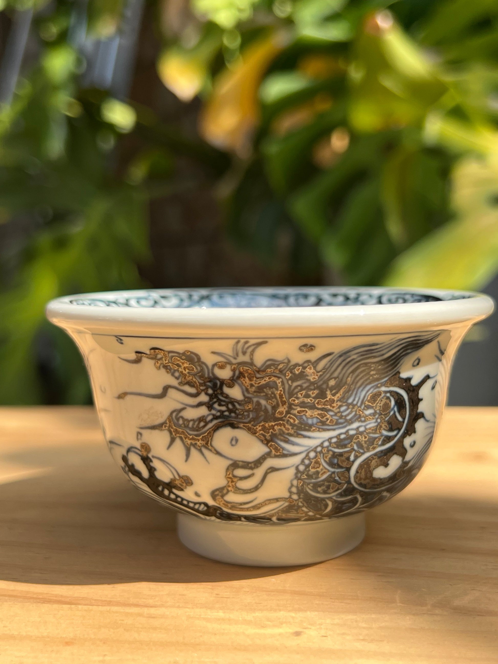 This is a Chinese Jingdezhen blue and white porcelain dragon tea cup