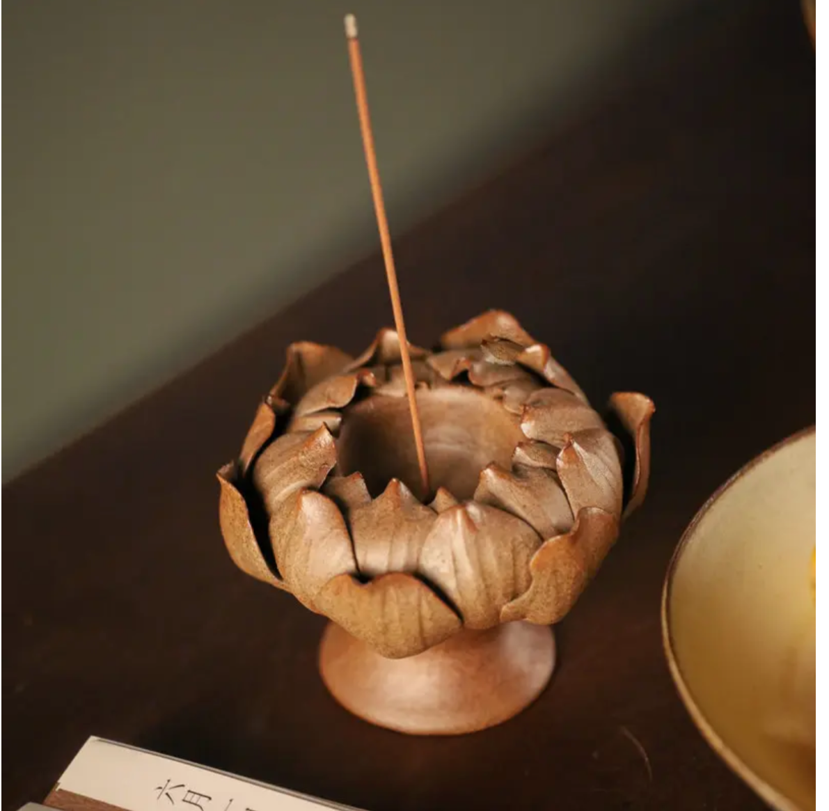 this is a pottery candlestick incense holder