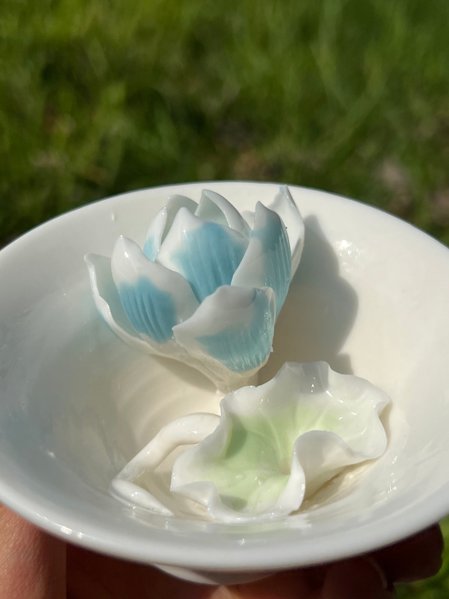 this is a woodfired white fine pottery flower teacup