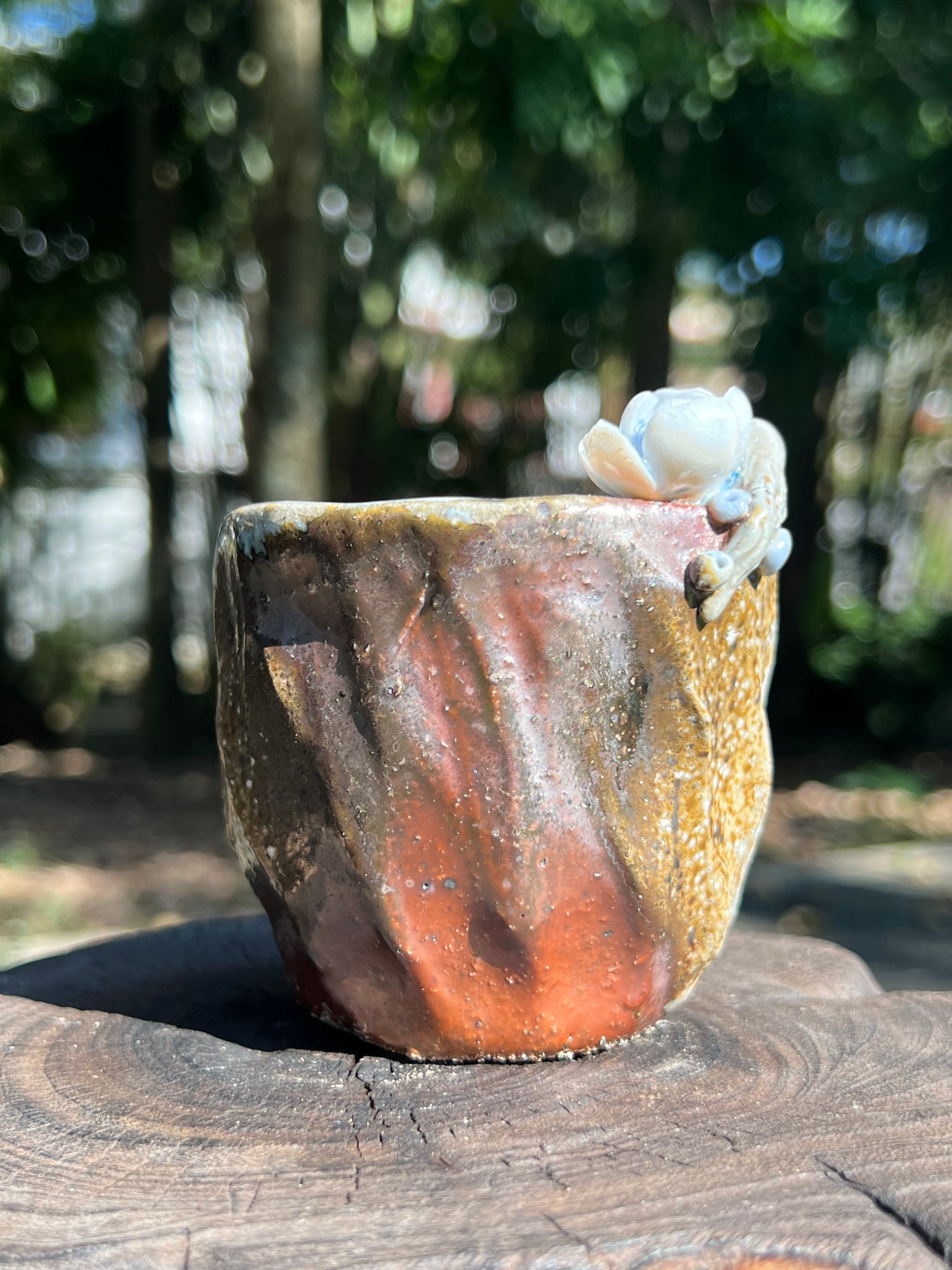 This is a woodfired pottery flower teacup