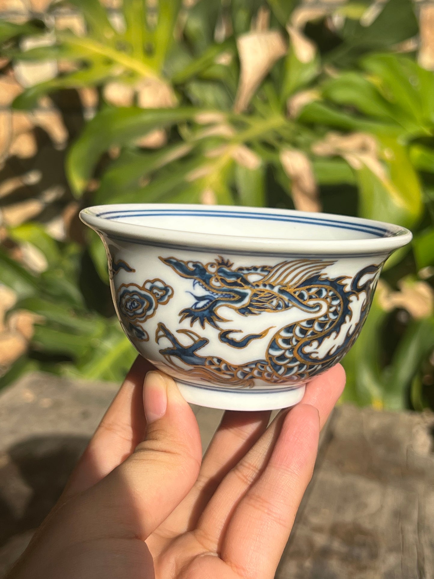 This is a Chinese Jingdezhen blue and white porcelain dragon tea cup