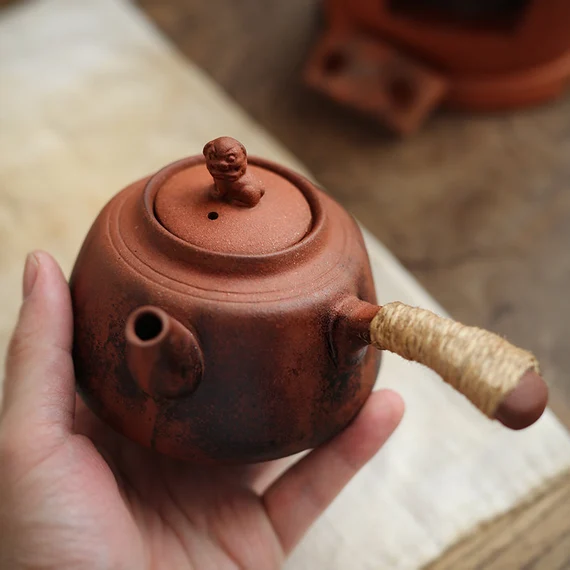 This is a pottery side handle kettle