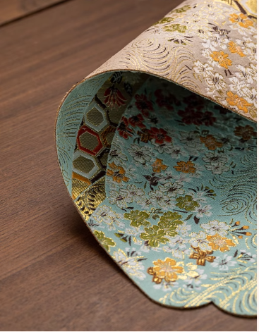 This is a silk brocade tea mat.this is a waterproof table cloth