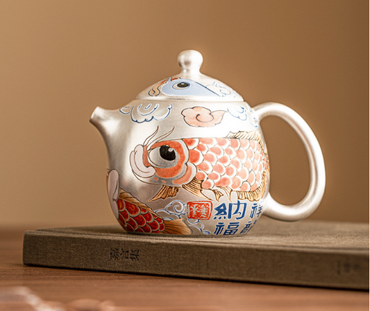  this is a gilded silver teapot. this is a ceramic teapot