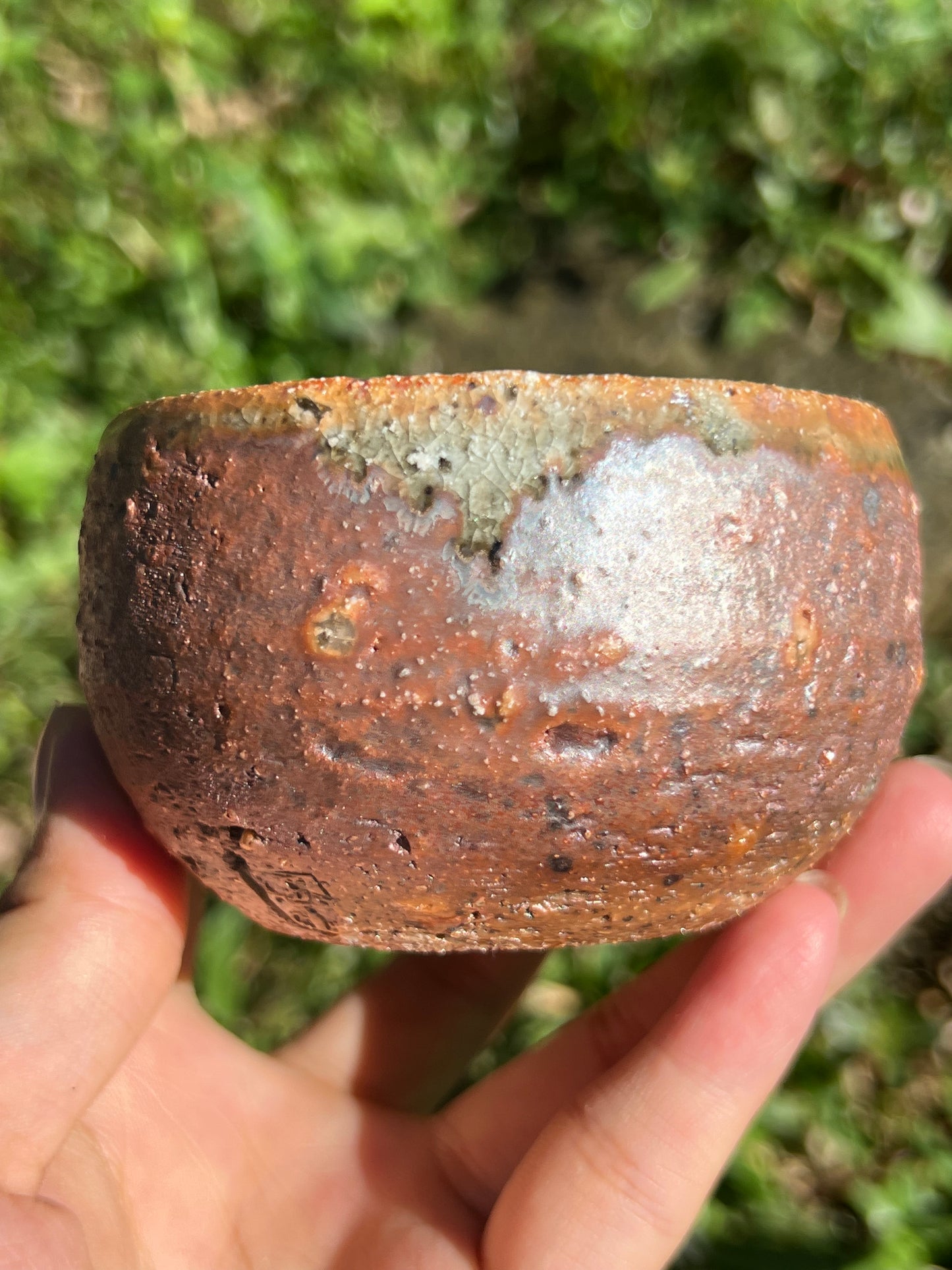 This is a woodfired pottery flower teacup