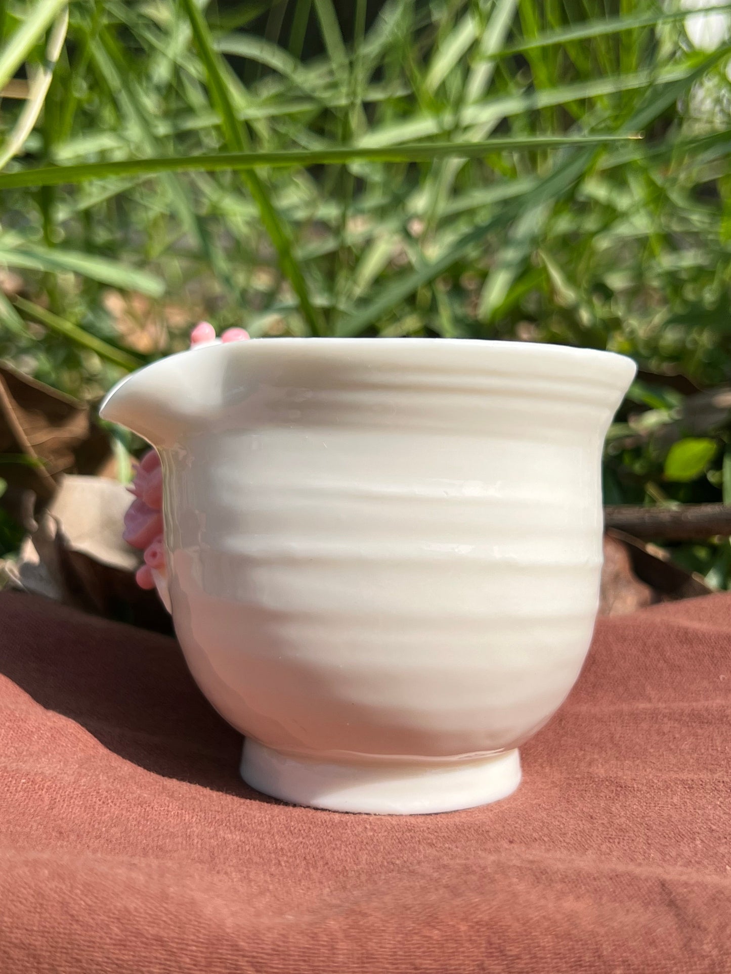 this is a woodfired white fine pottery flower teacup