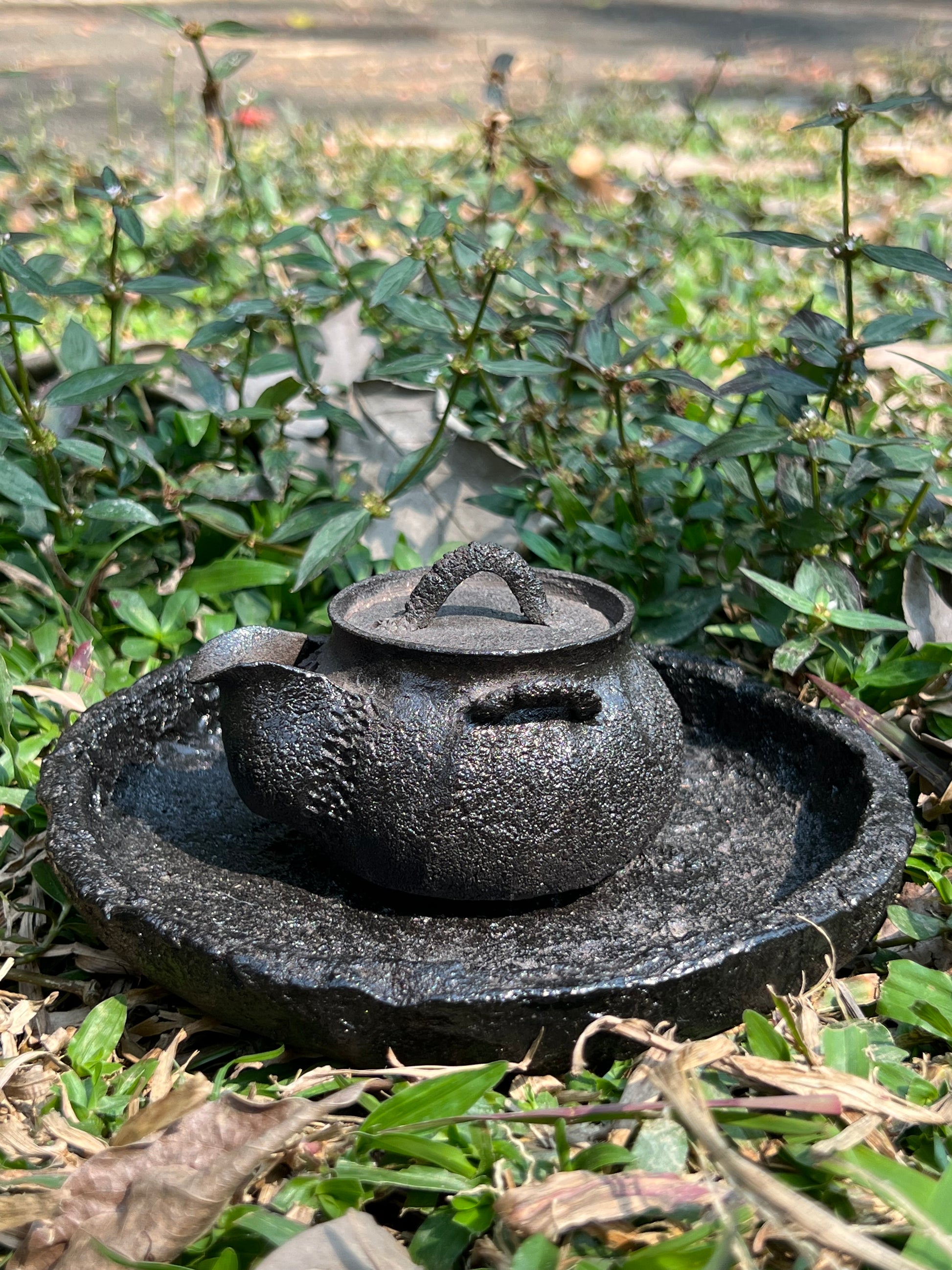 This is a purple clay teapot set