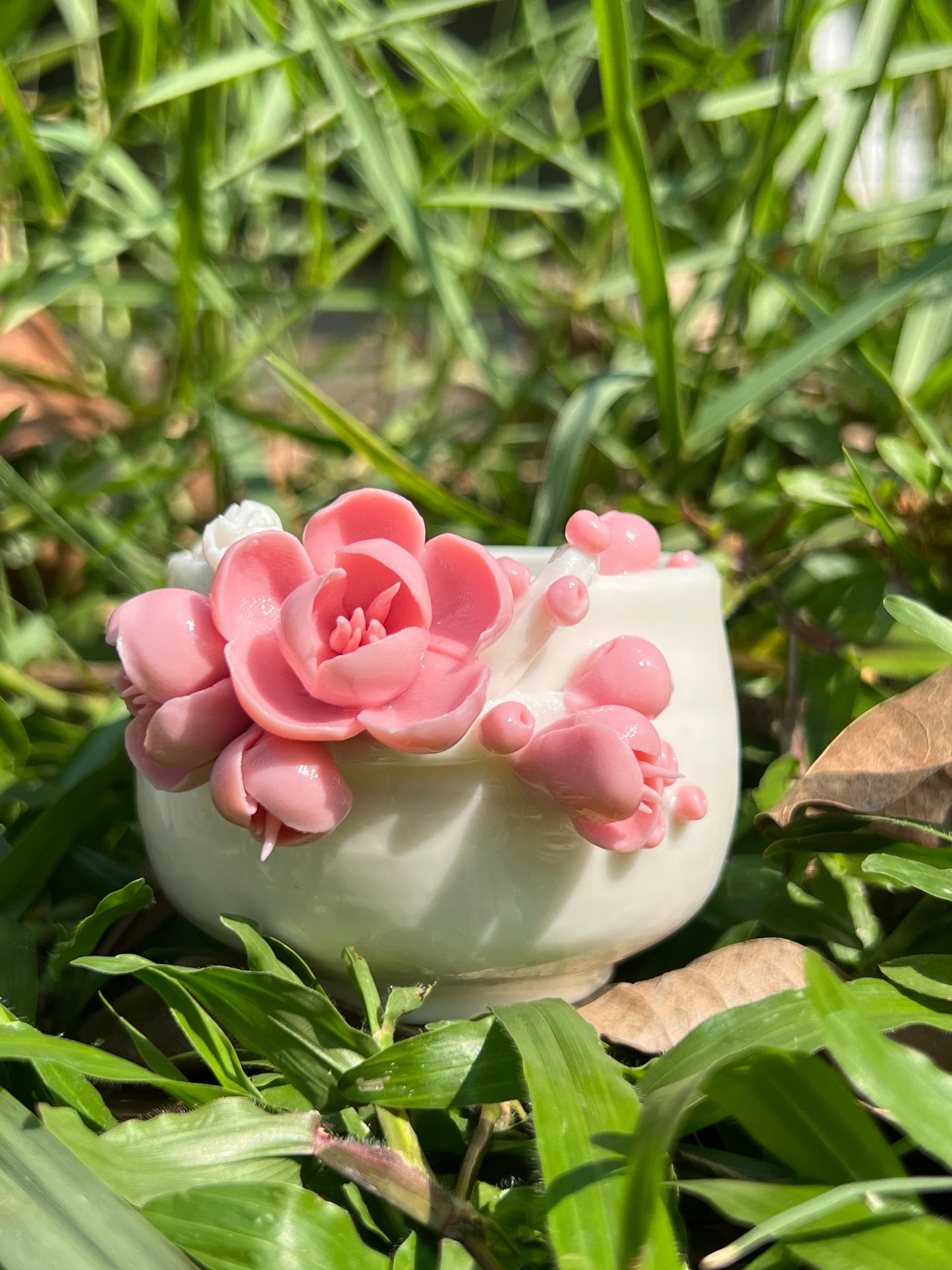 this is a woodfired white fine pottery flower teacup