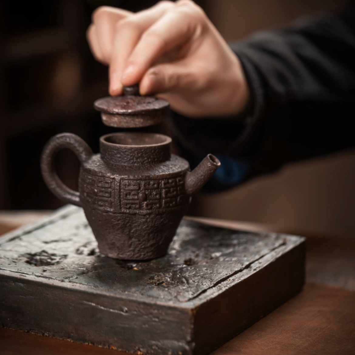 this is a pottery teapot. this is a purple clay teapot