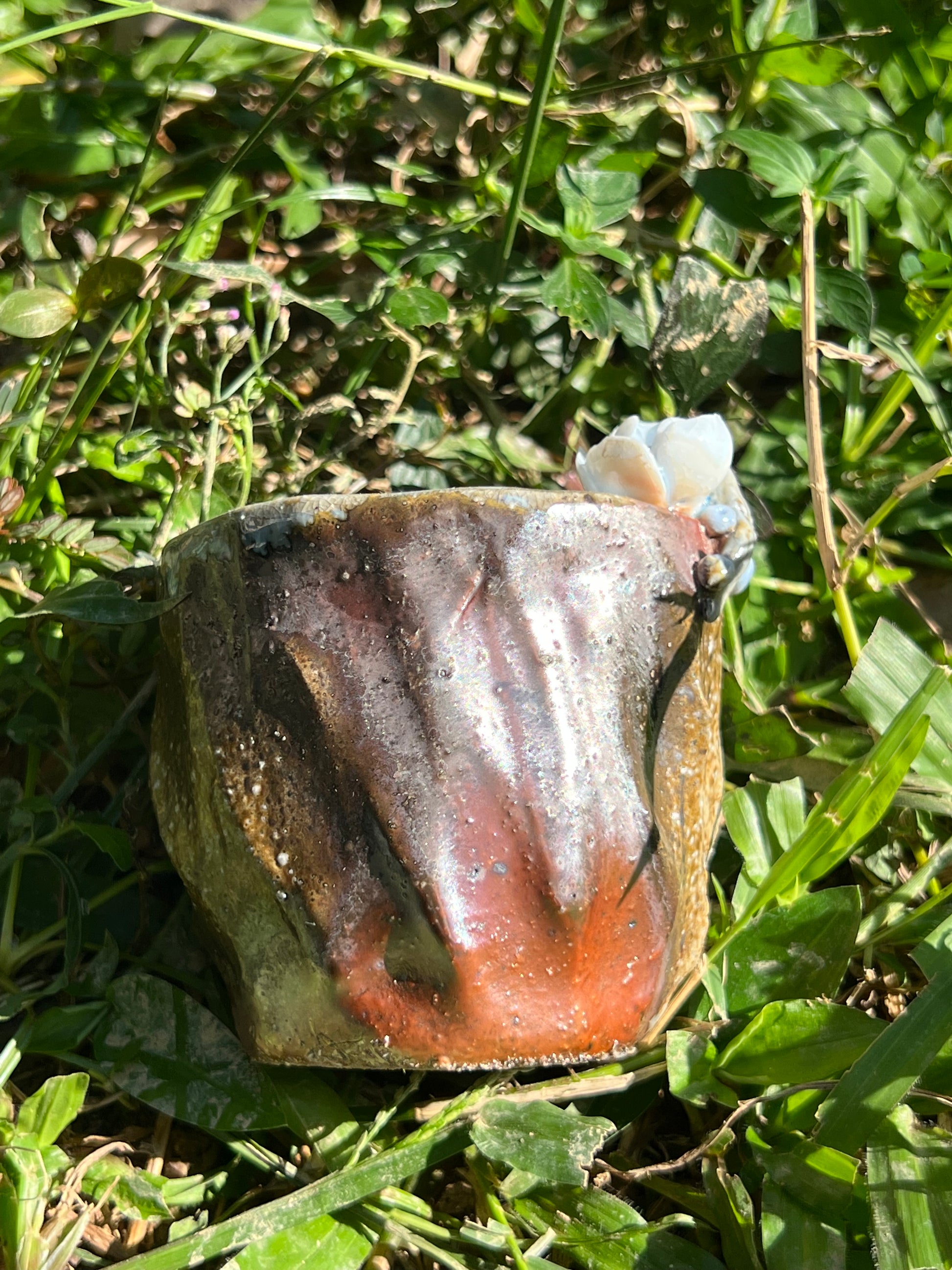 This is a woodfired pottery flower teacup