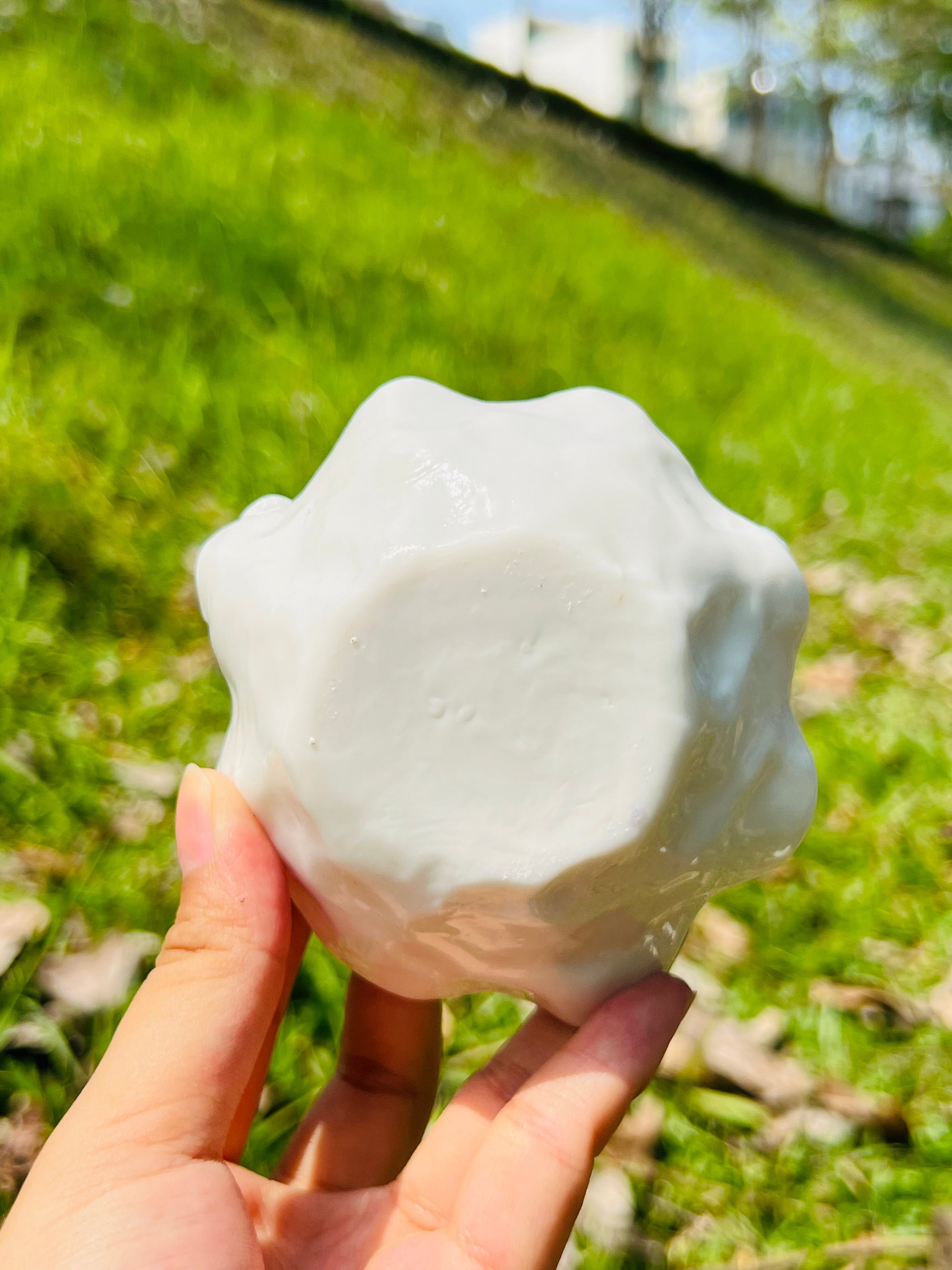 this is a woodfired white fine pottery flower teacup