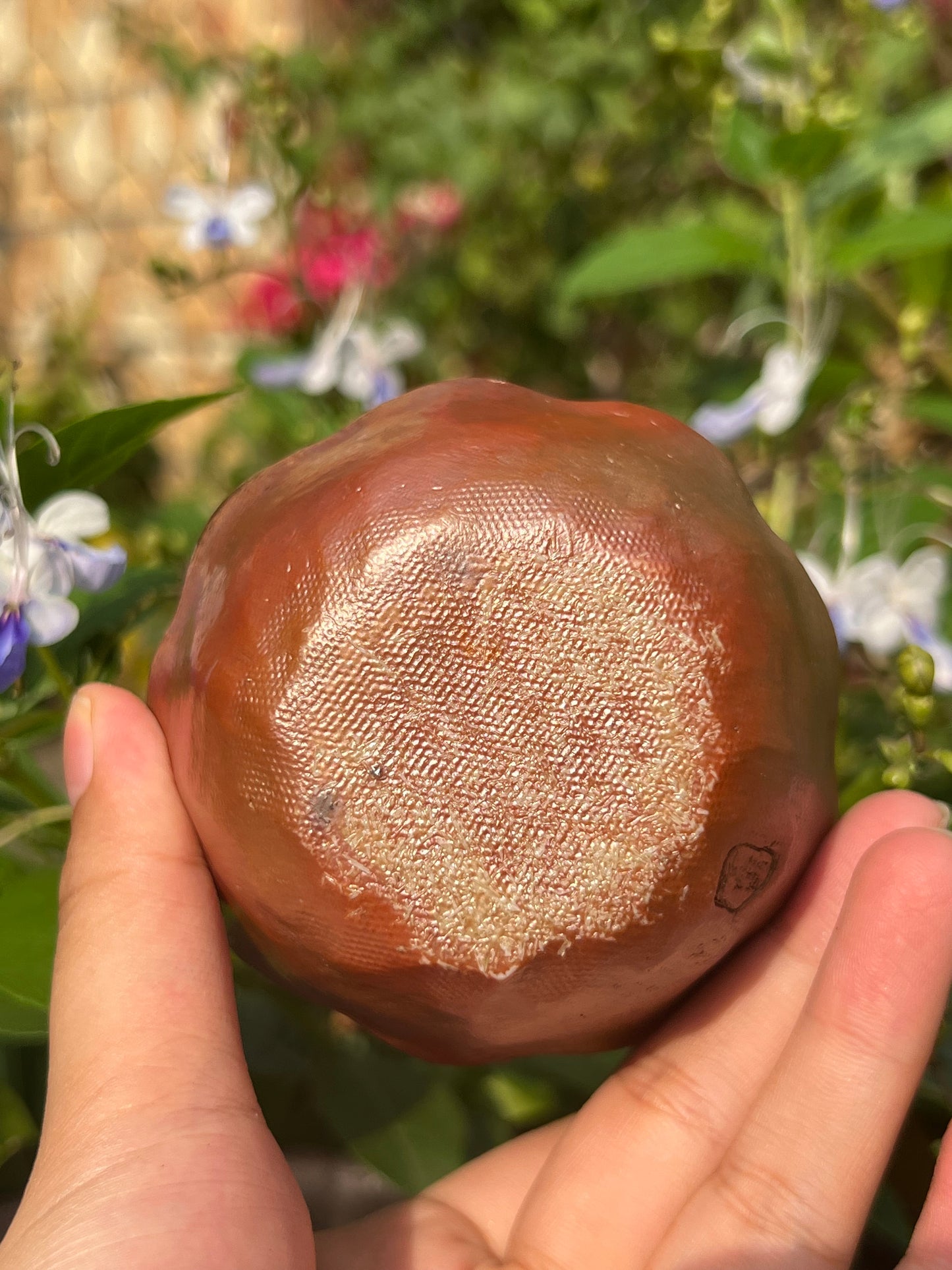 This is a woodfired pottery flower teacup