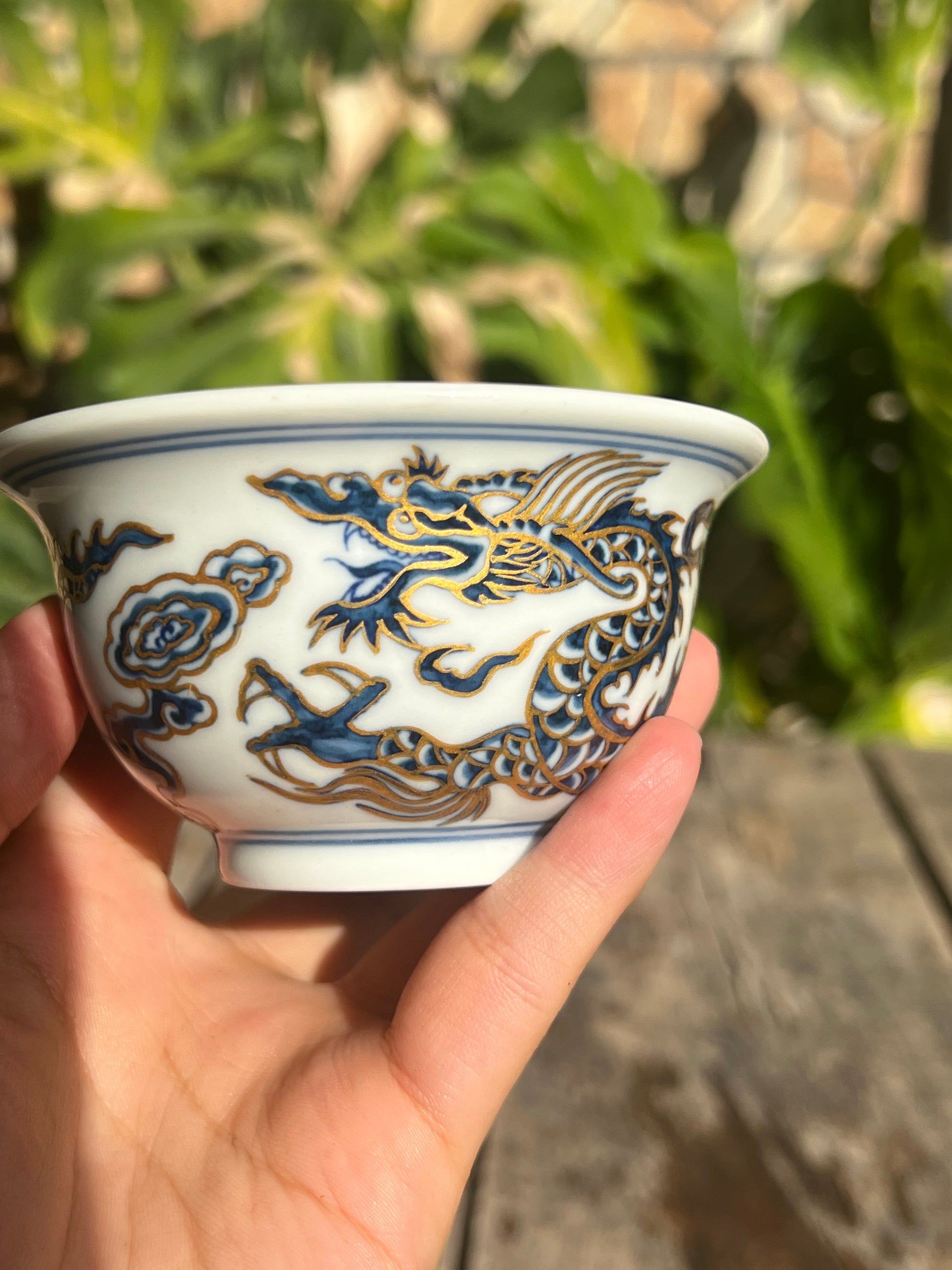 This is a Chinese Jingdezhen blue and white porcelain dragon tea cup