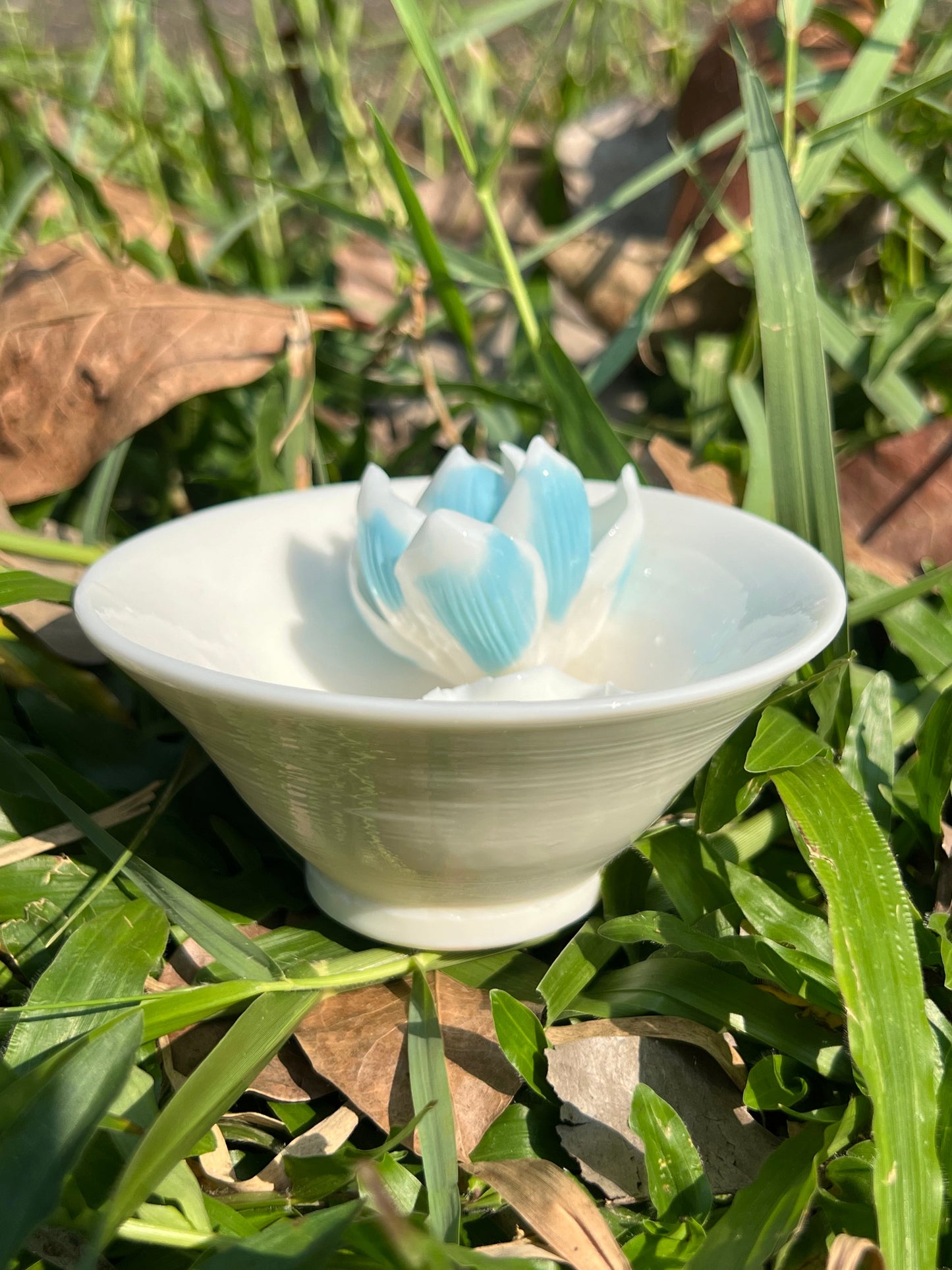 this is a woodfired white fine pottery flower teacup