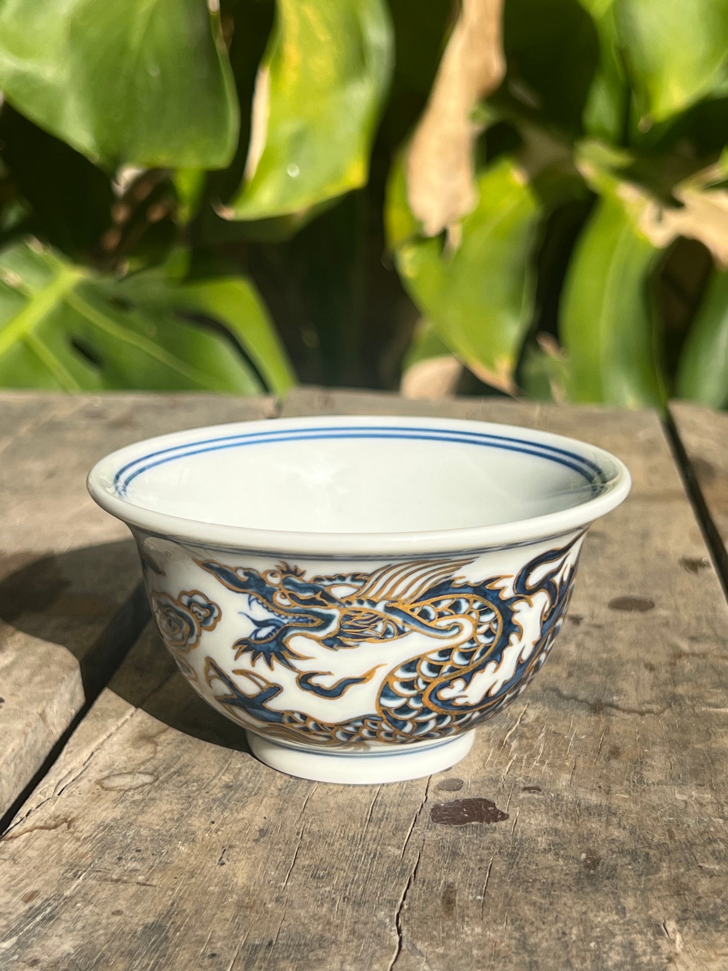 This is a Chinese Jingdezhen blue and white porcelain dragon tea cup