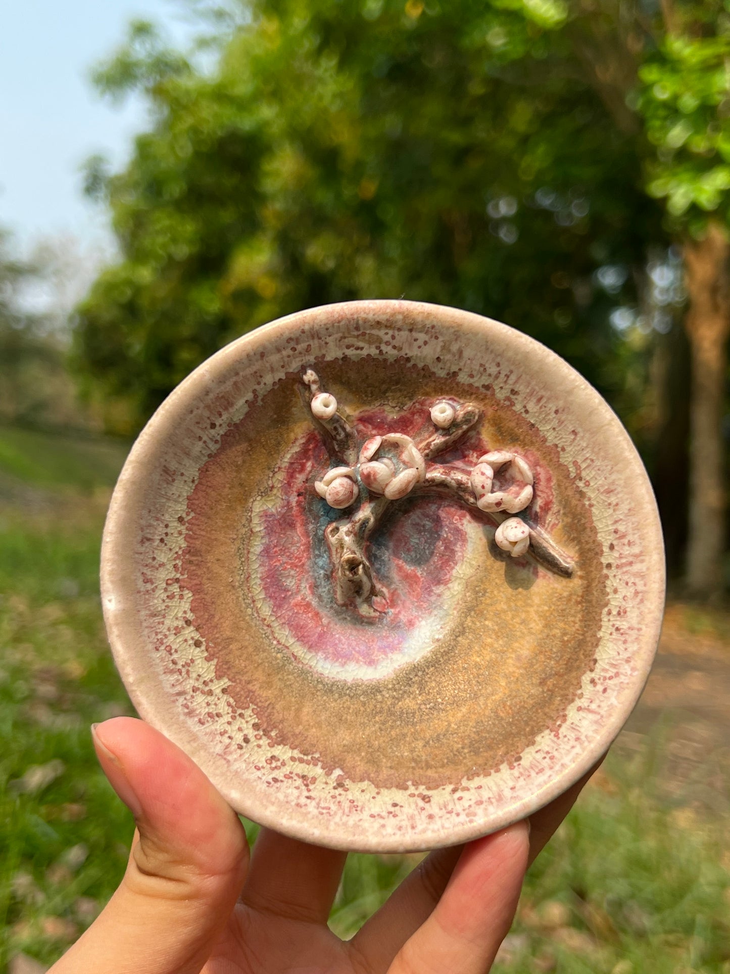 This is a woodfired pottery flower teacup