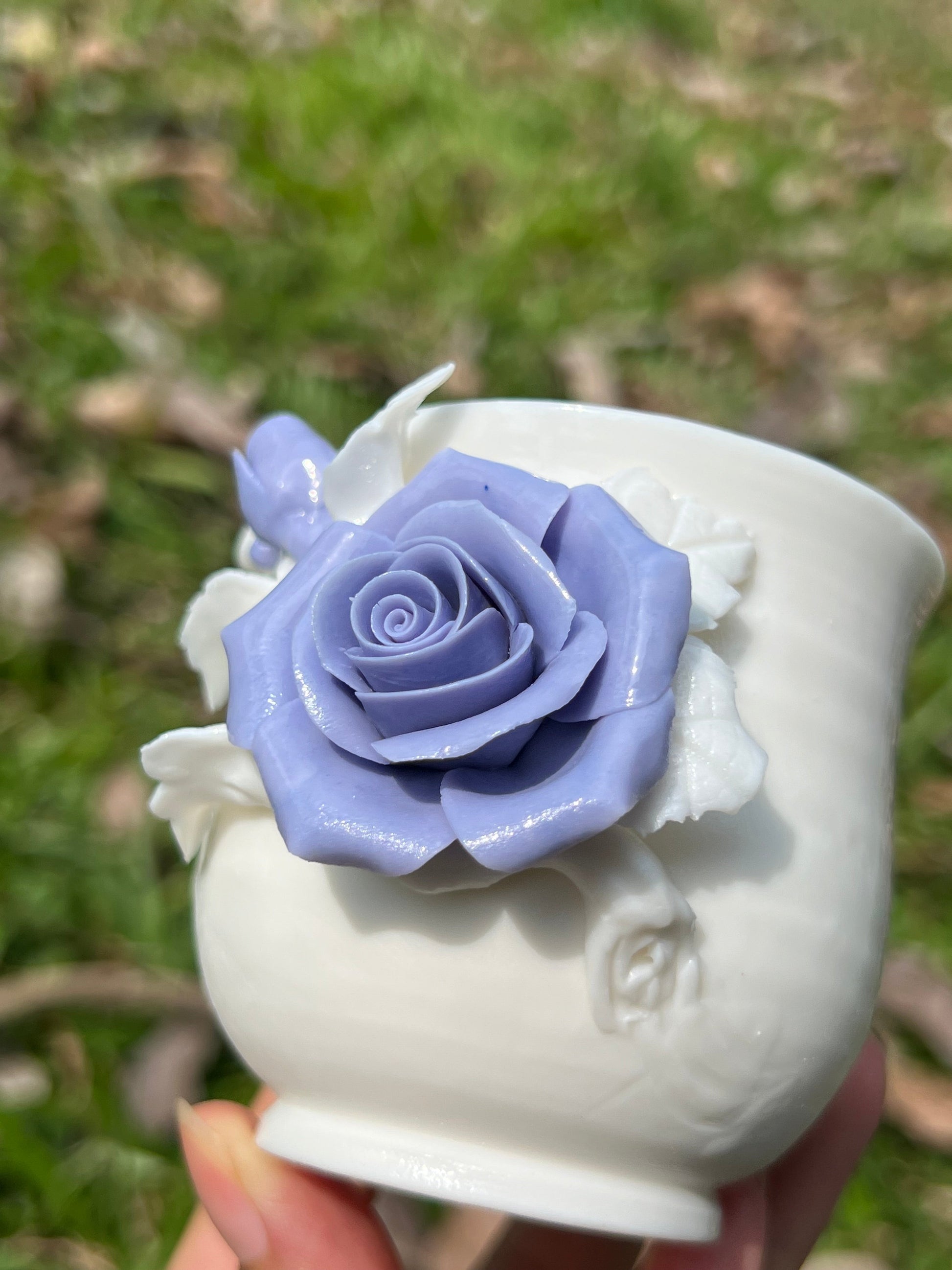 this is a woodfired white fine pottery flower teacup