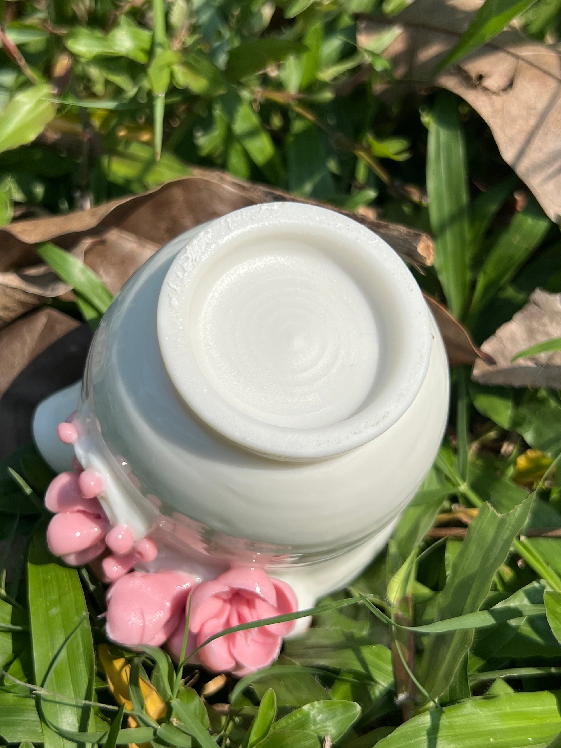 this is a woodfired white fine pottery flower teacup