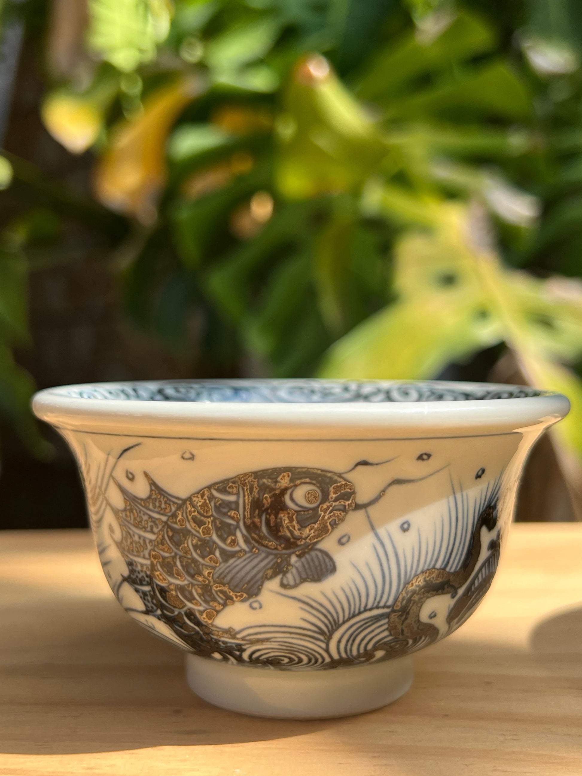 This is a Chinese Jingdezhen blue and white porcelain dragon tea cup