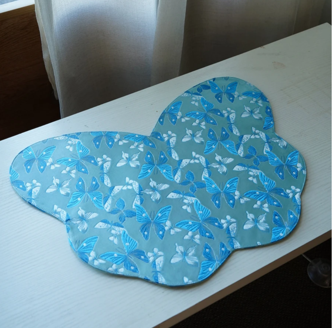 This is a silk brocade butterfly tea mat.this is a waterproof table cloth