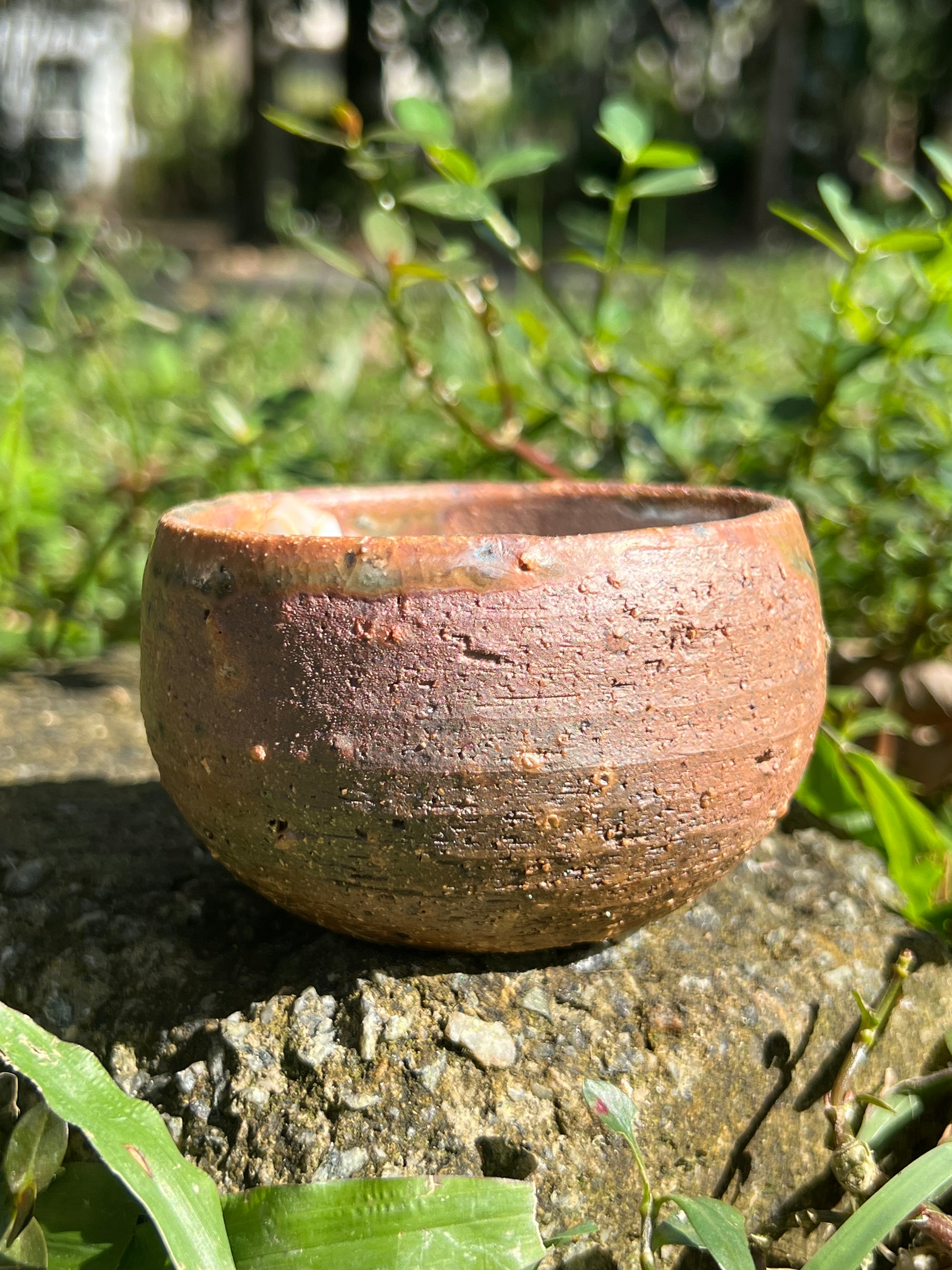 This is a woodfired pottery flower teacup