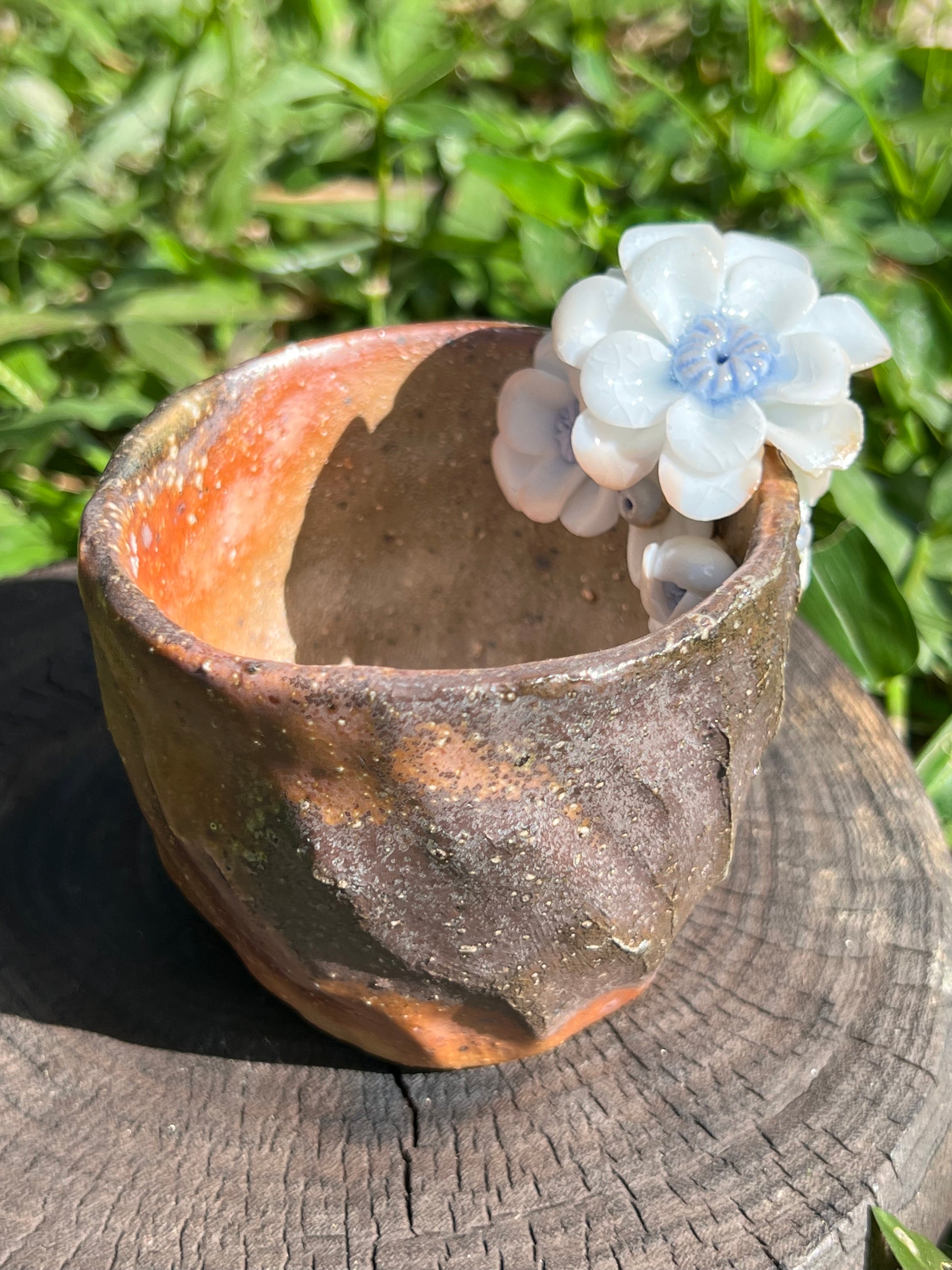 This is a woodfired pottery flower teacup