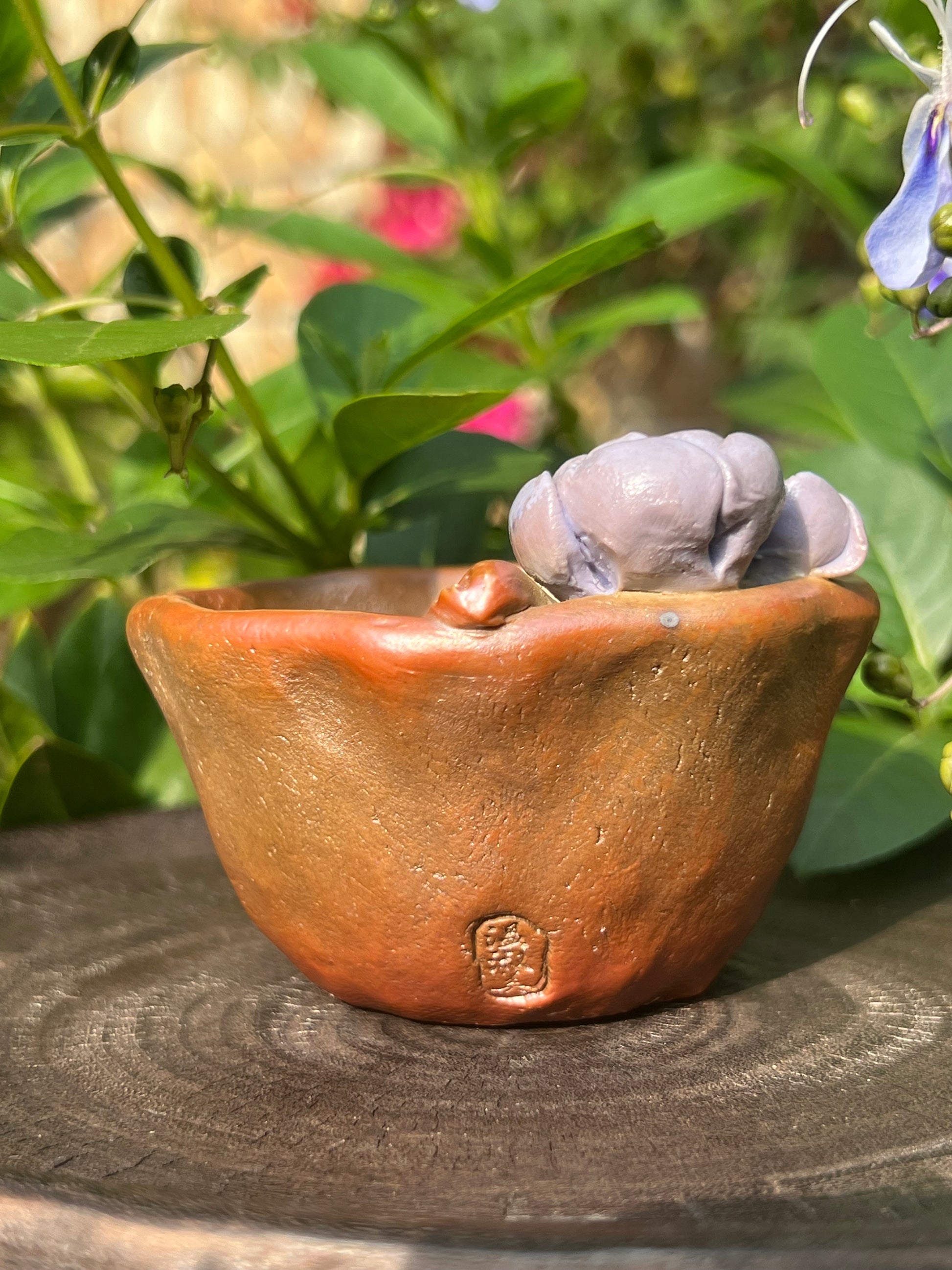 This is a woodfired pottery flower teacup