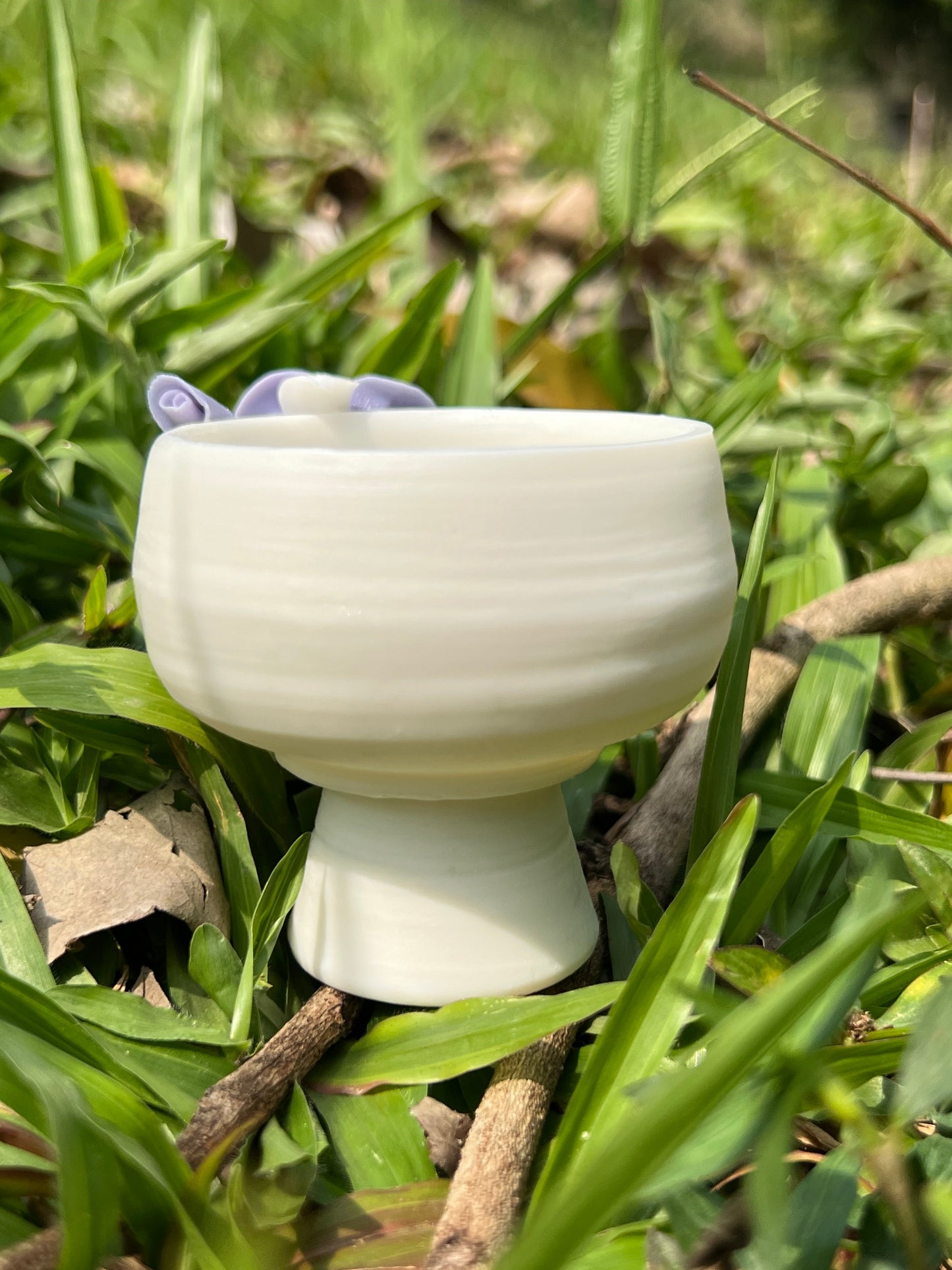 this is a woodfired white fine pottery flower teacup