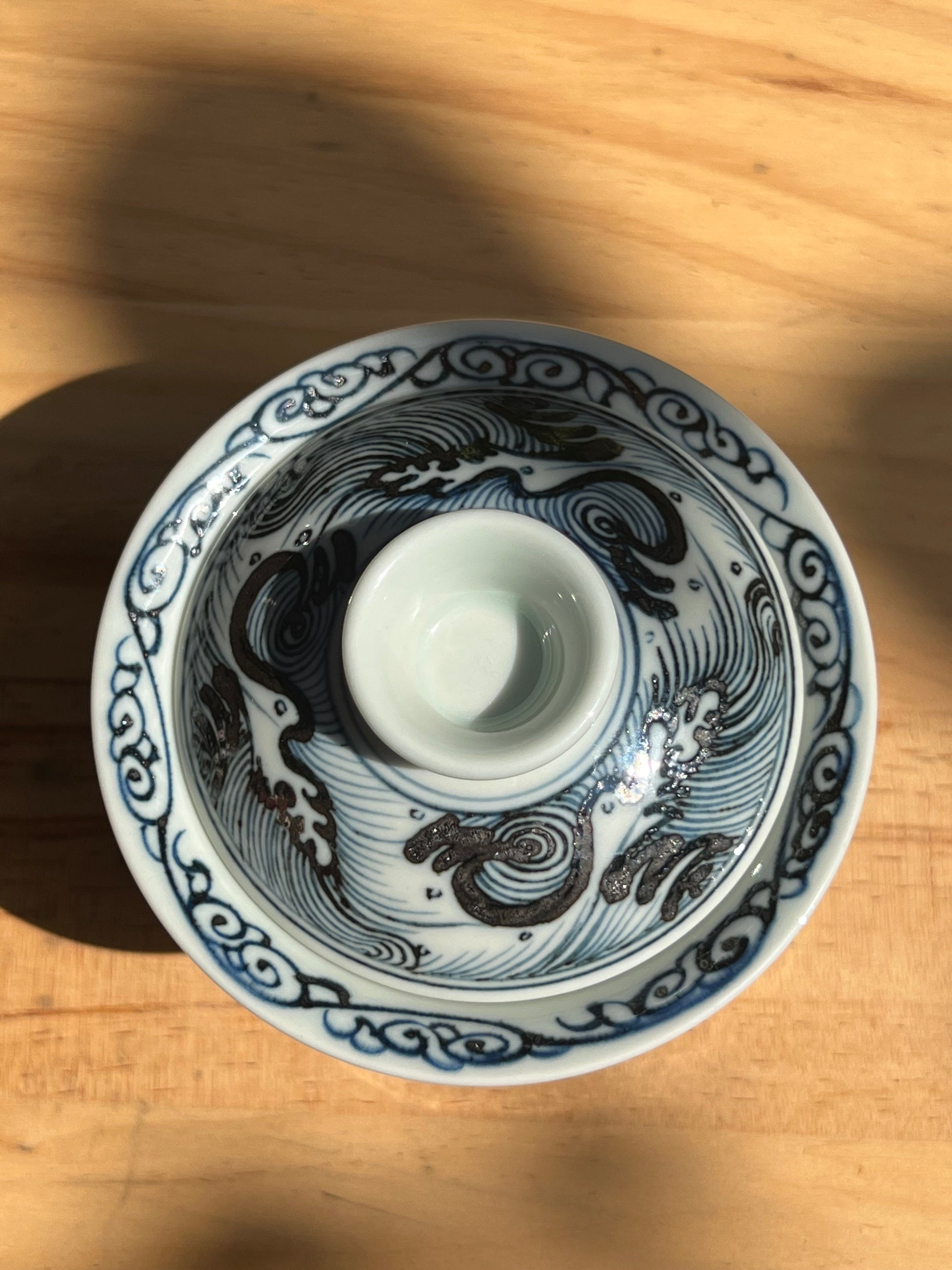 This is a Chinese Jingdezhen blue and white porcelain dragon tea cup