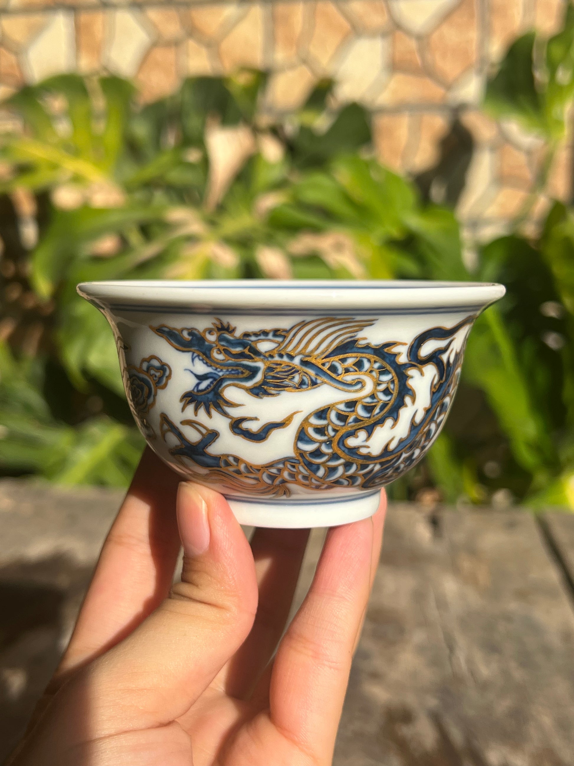 This is a Chinese Jingdezhen blue and white porcelain dragon tea cup