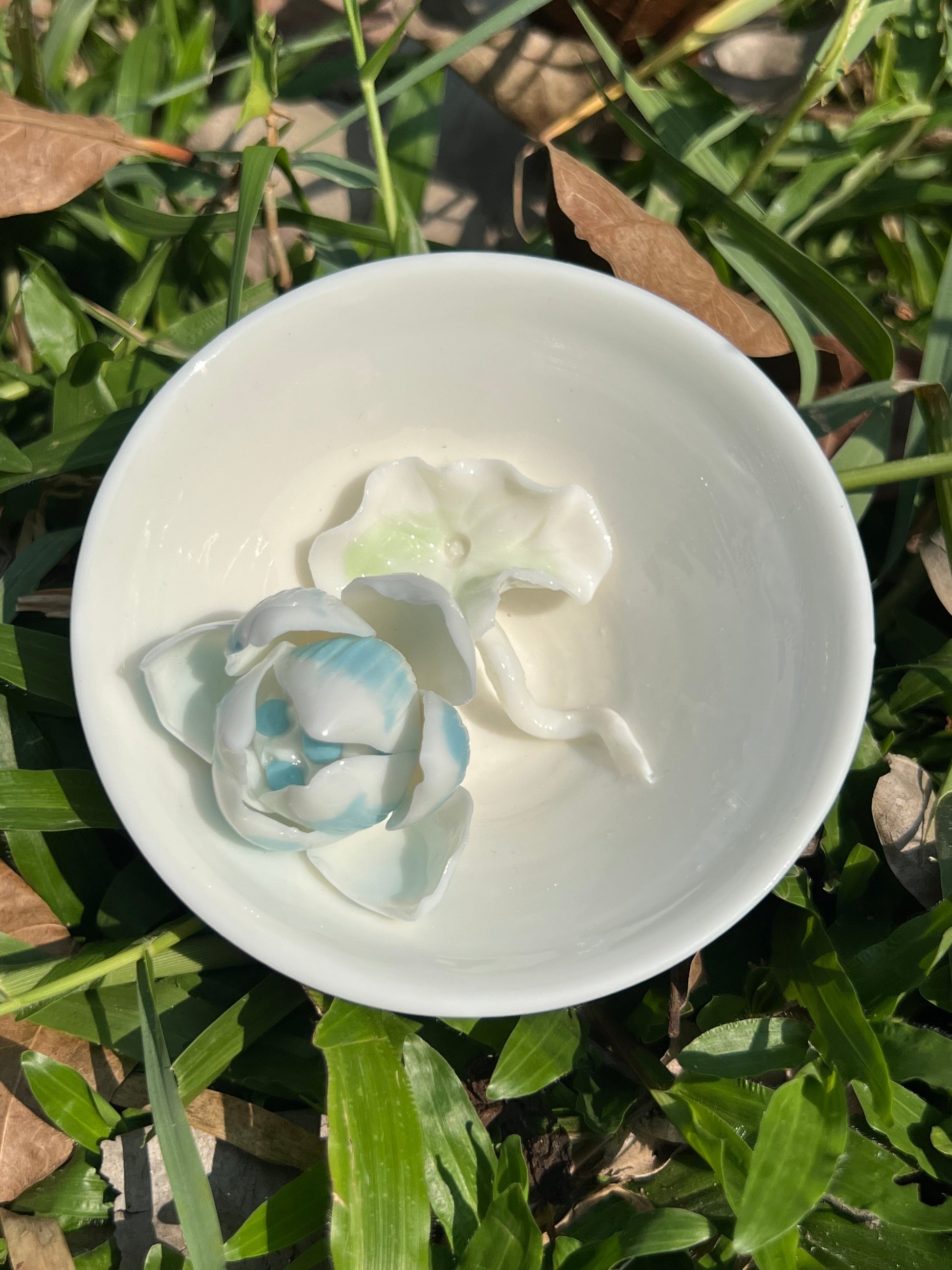 this is a woodfired white fine pottery flower teacup