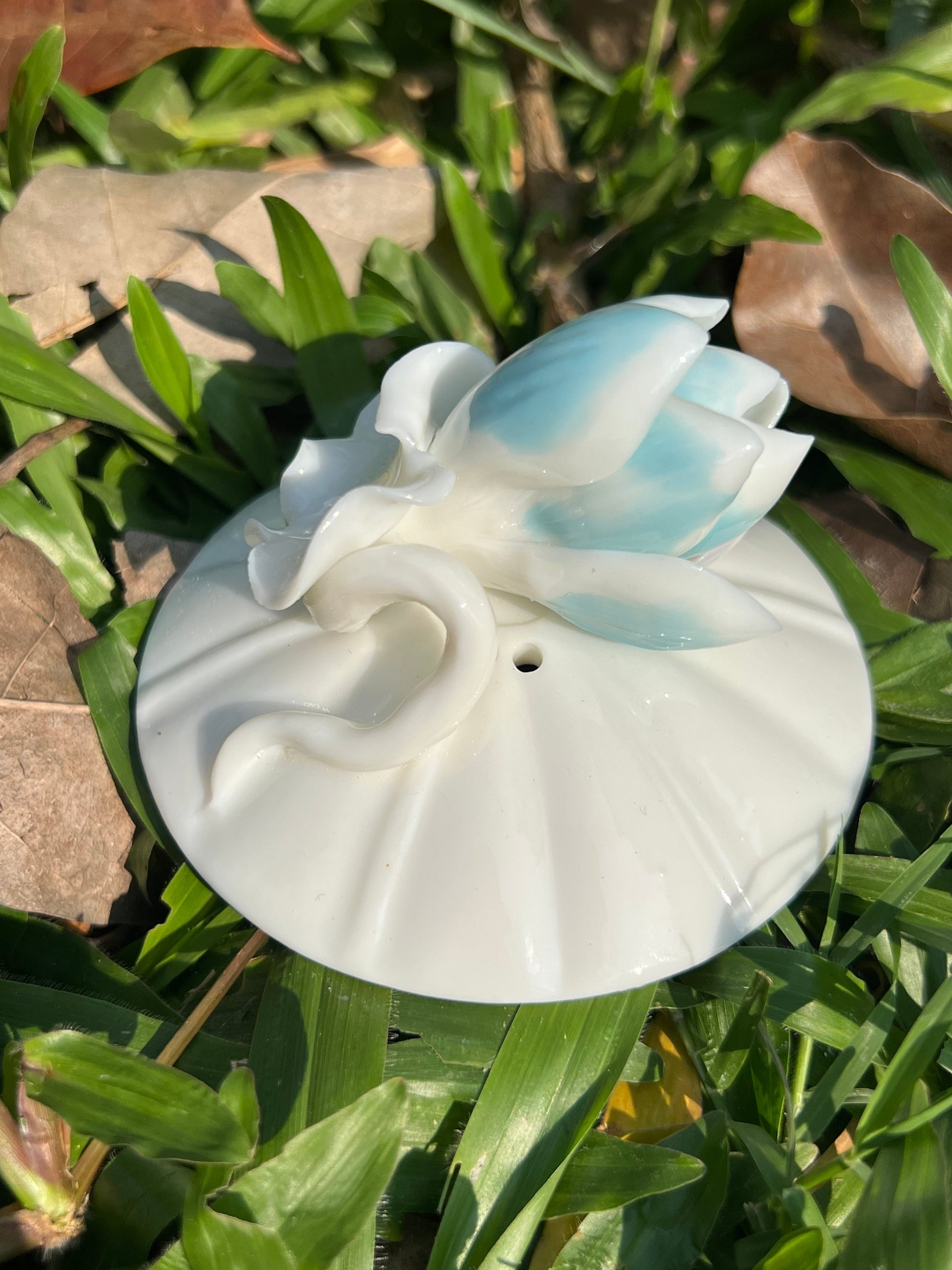 this is a woodfired white fine pottery flower teacup