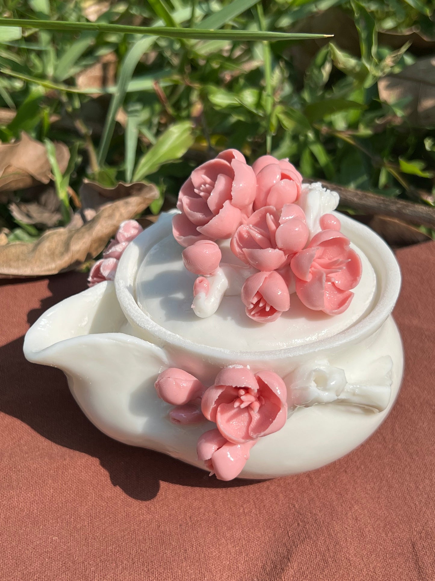 this is a woodfired white fine pottery flower teacup