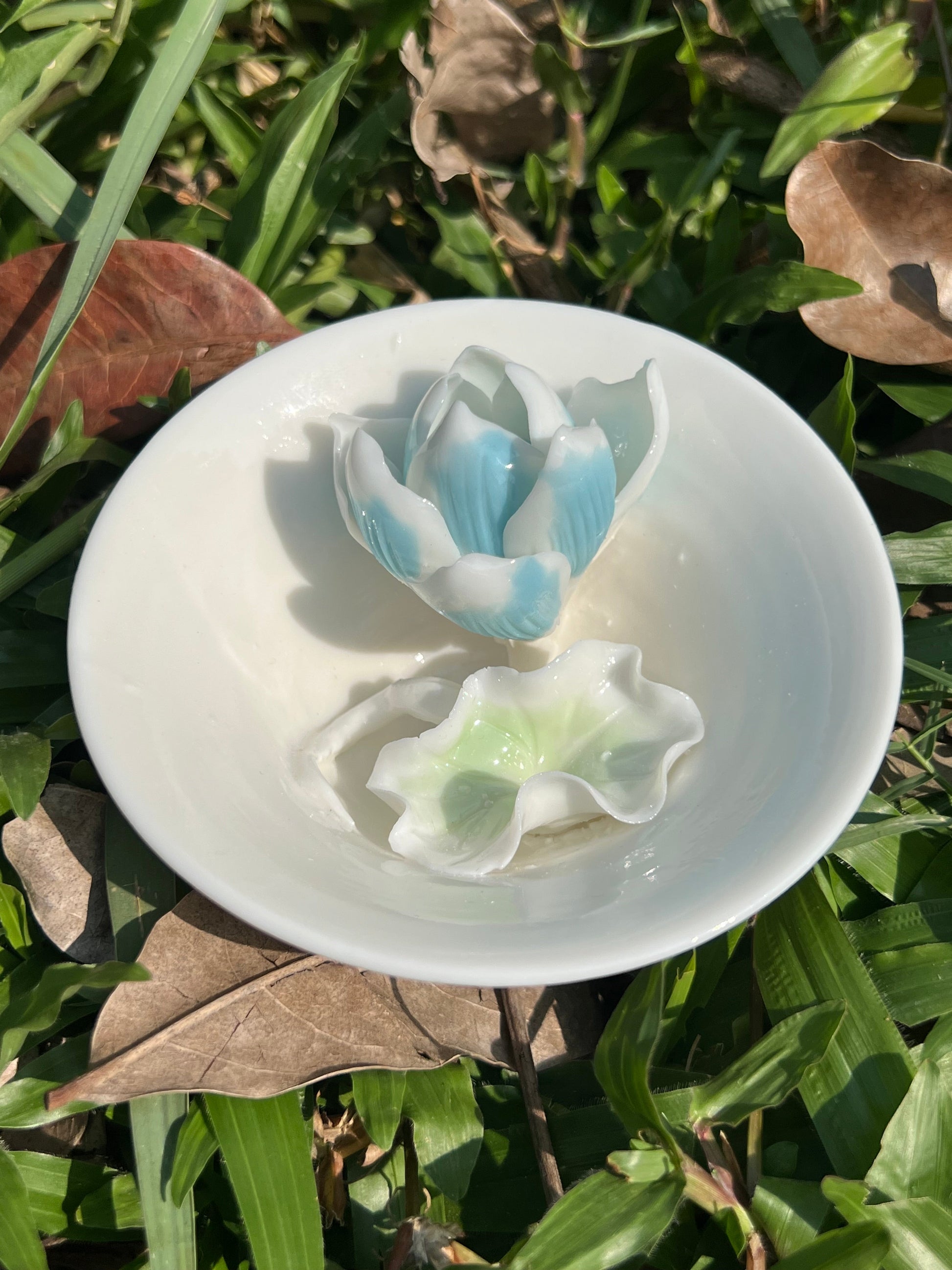 this is a woodfired white fine pottery flower teacup