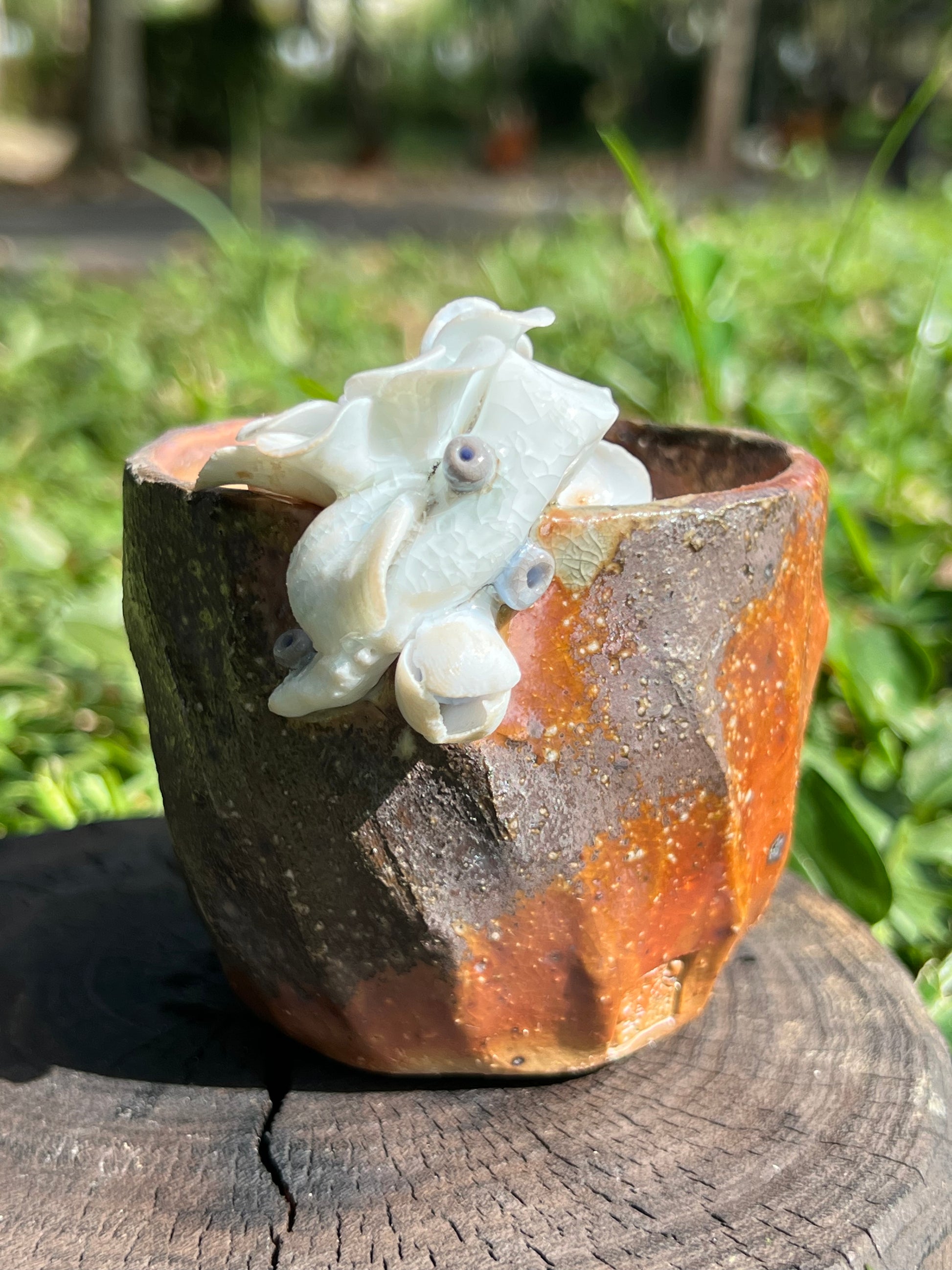 This is a woodfired pottery flower teacup