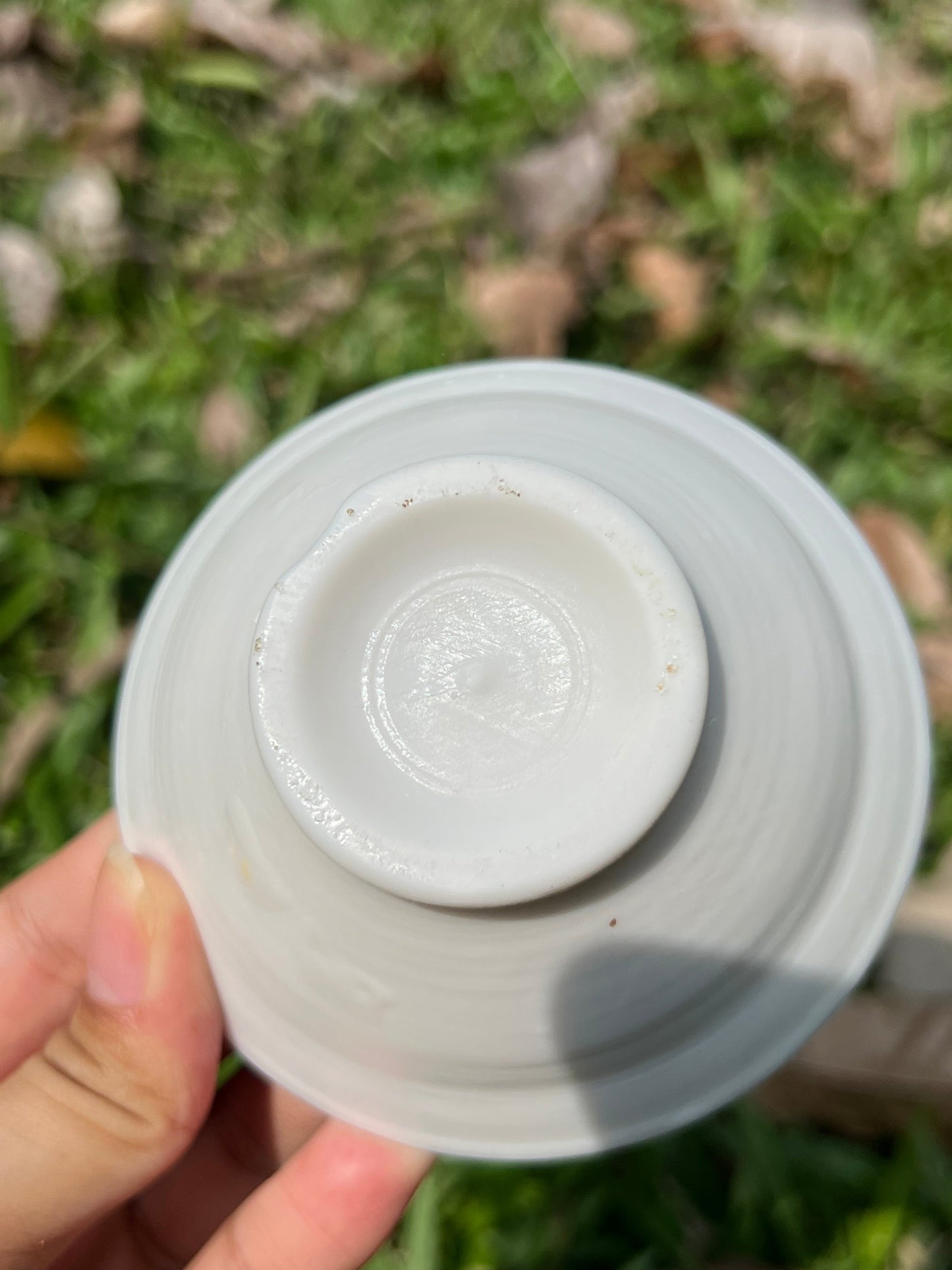 this is a woodfired white fine pottery flower teacup