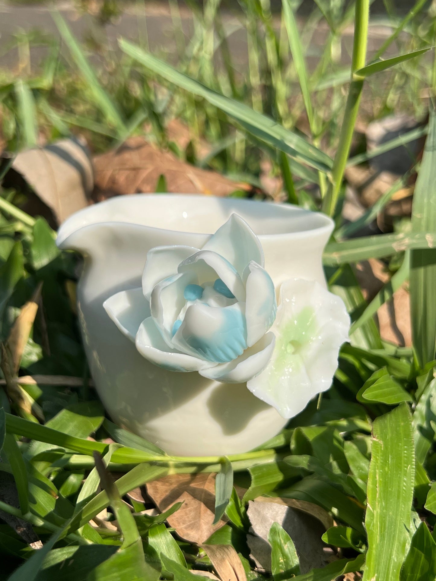 this is a woodfired white fine pottery flower teacup