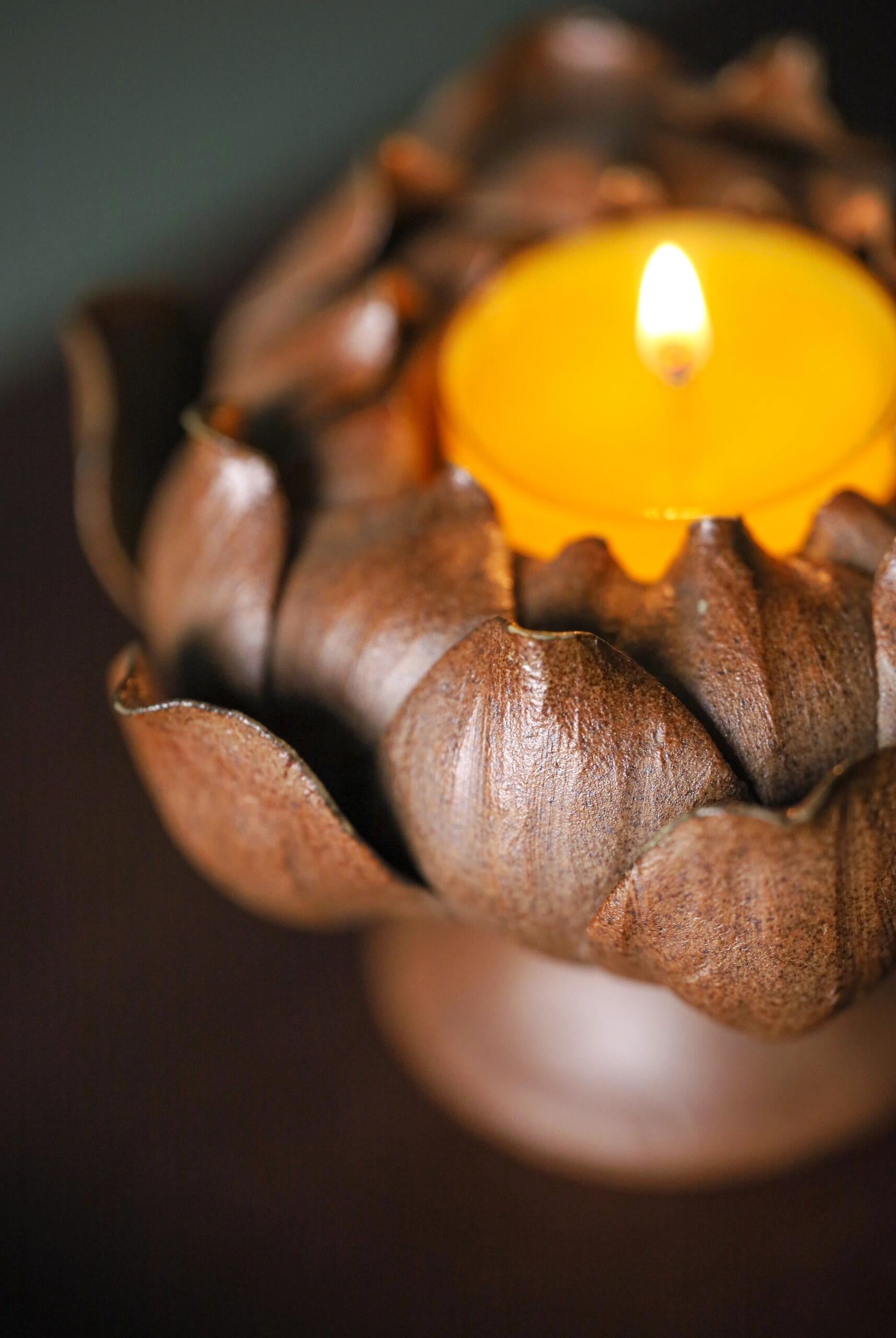 this is a pottery candlestick incense holder