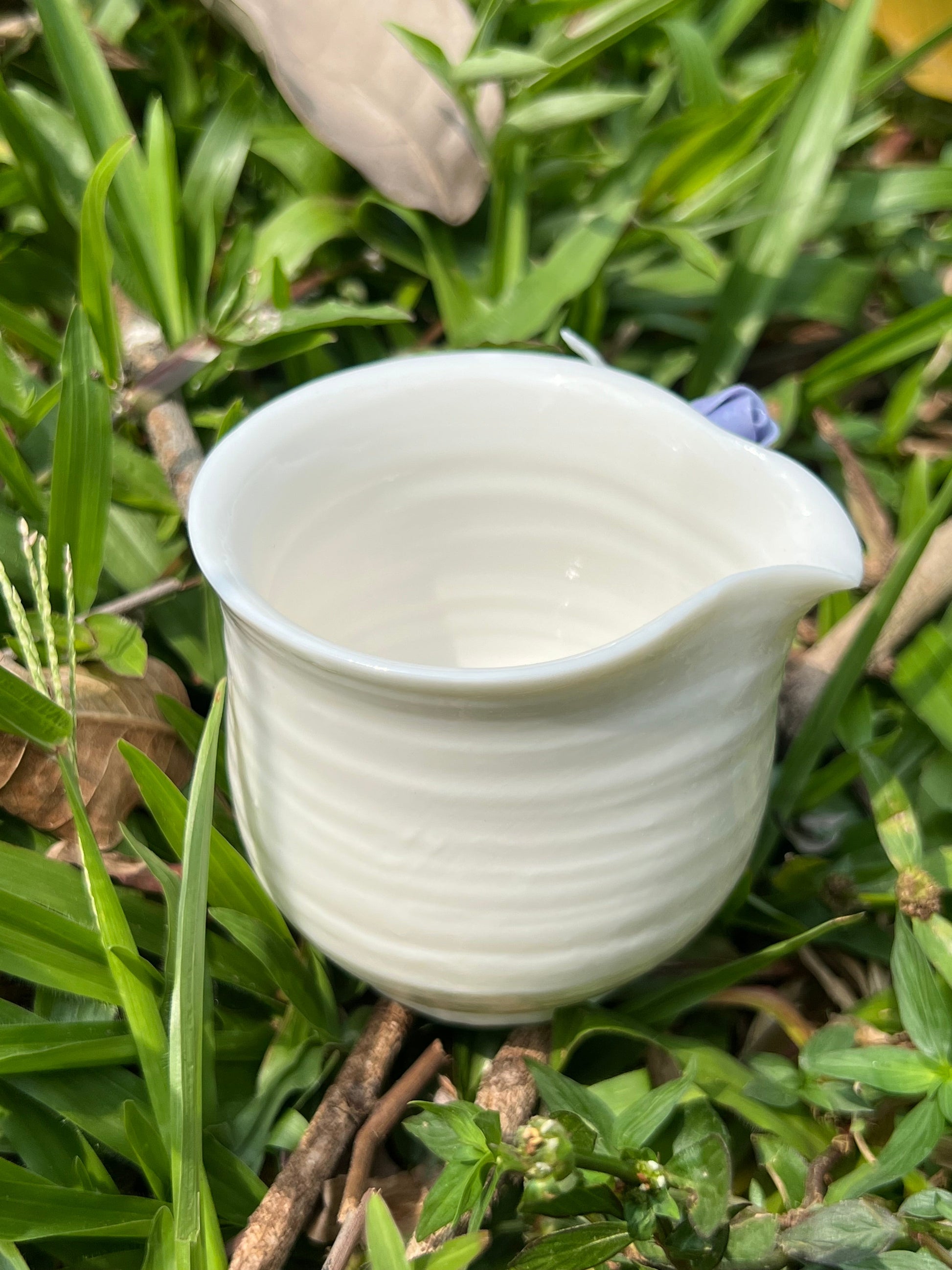 This is a woodfired white pottery flower faircup gongdaobei