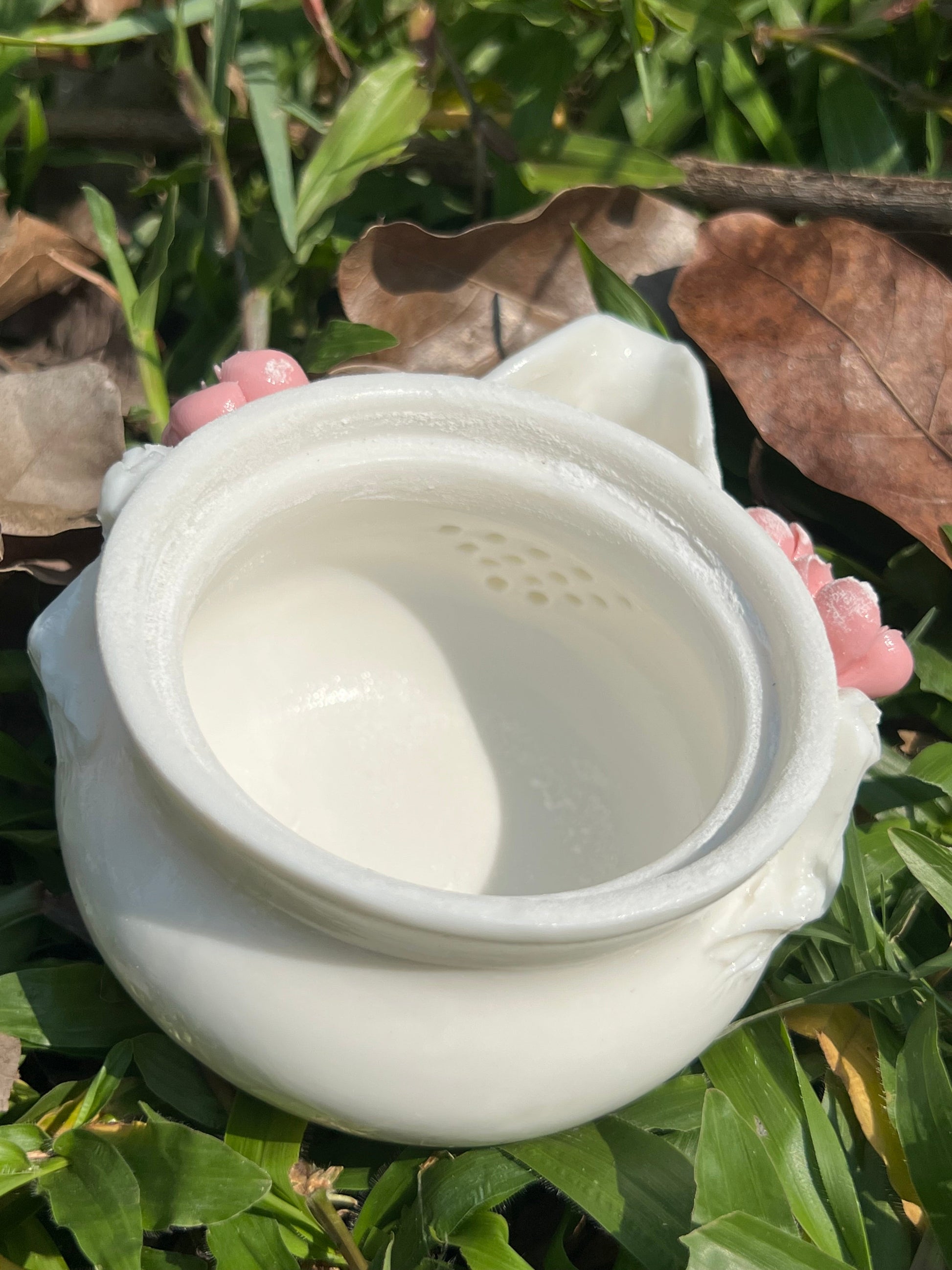 this is a woodfired white fine pottery flower teacup