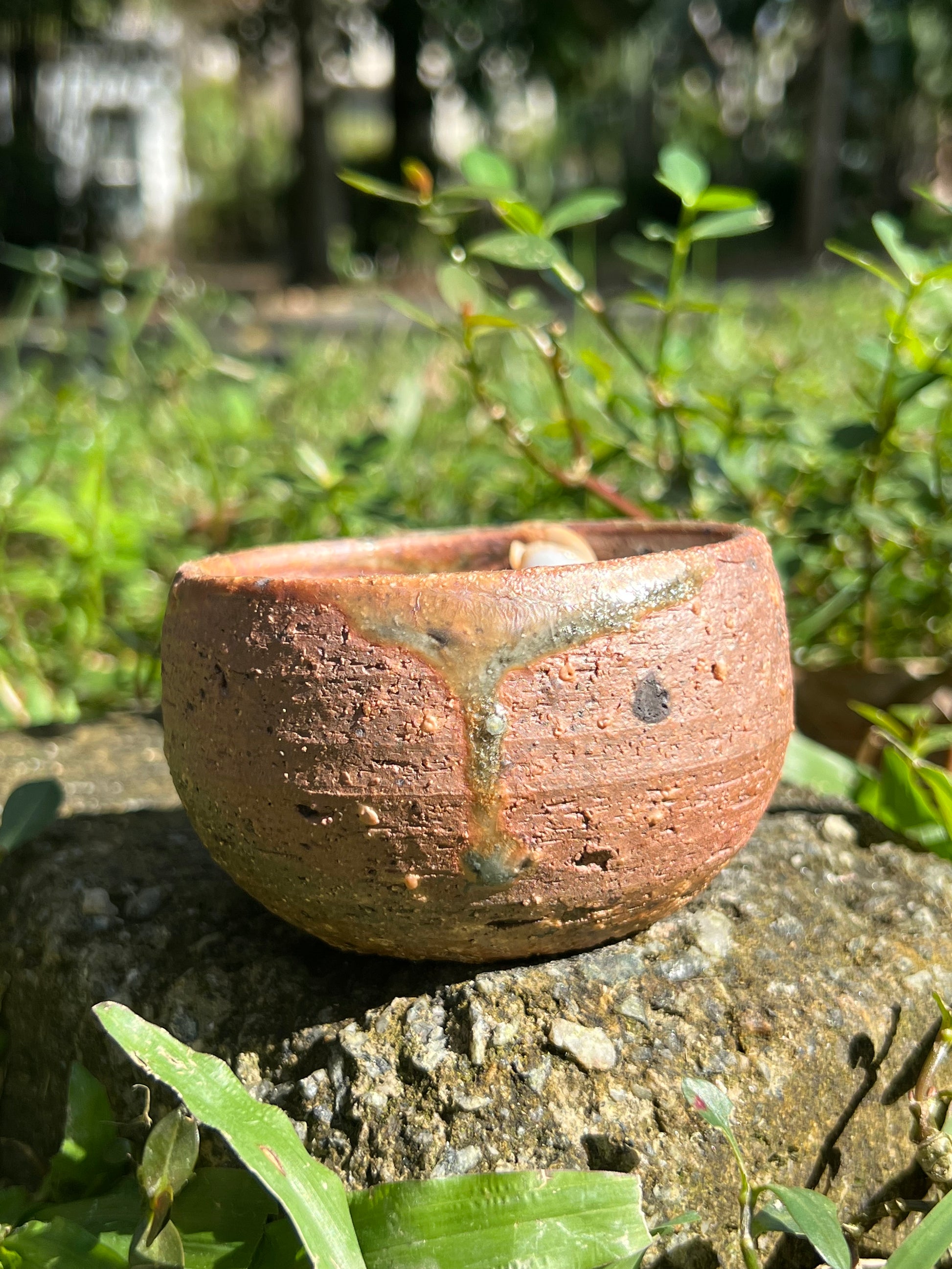 This is a woodfired pottery flower teacup