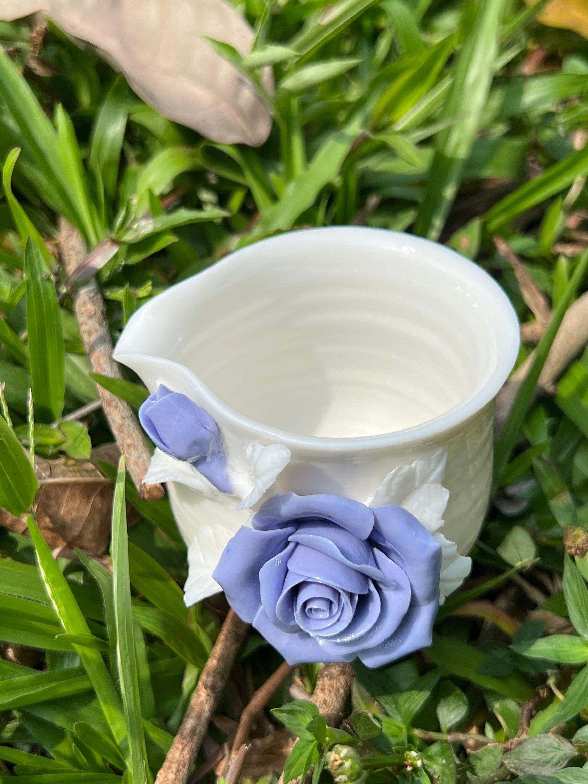 this is a woodfired white fine pottery flower teacup