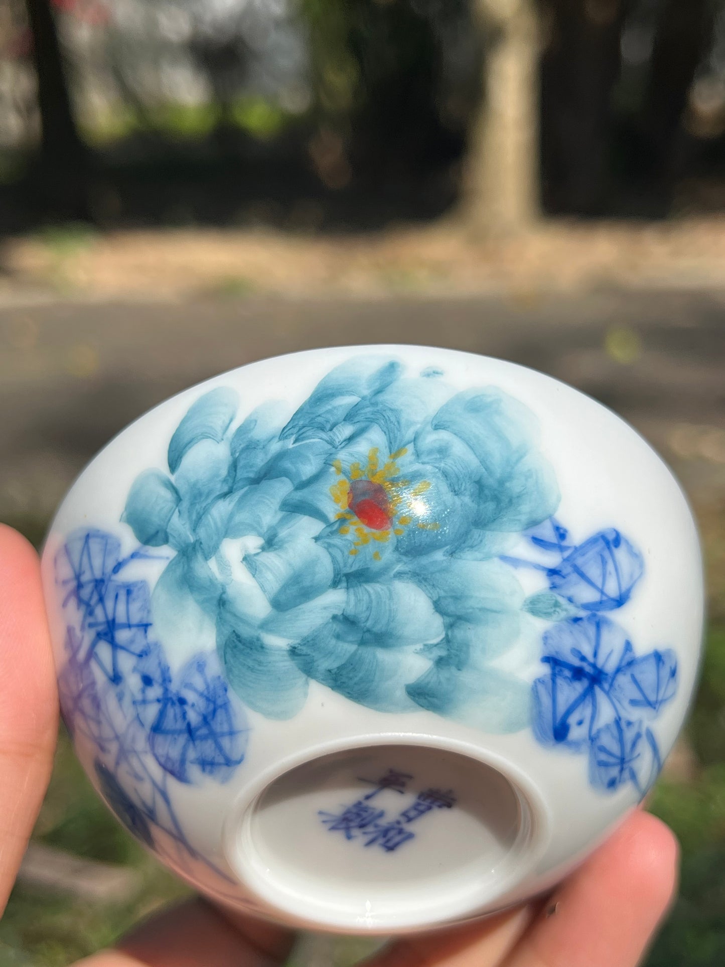 This is a Chinese Jingdezhen blue and white porcelain peony flower teacup