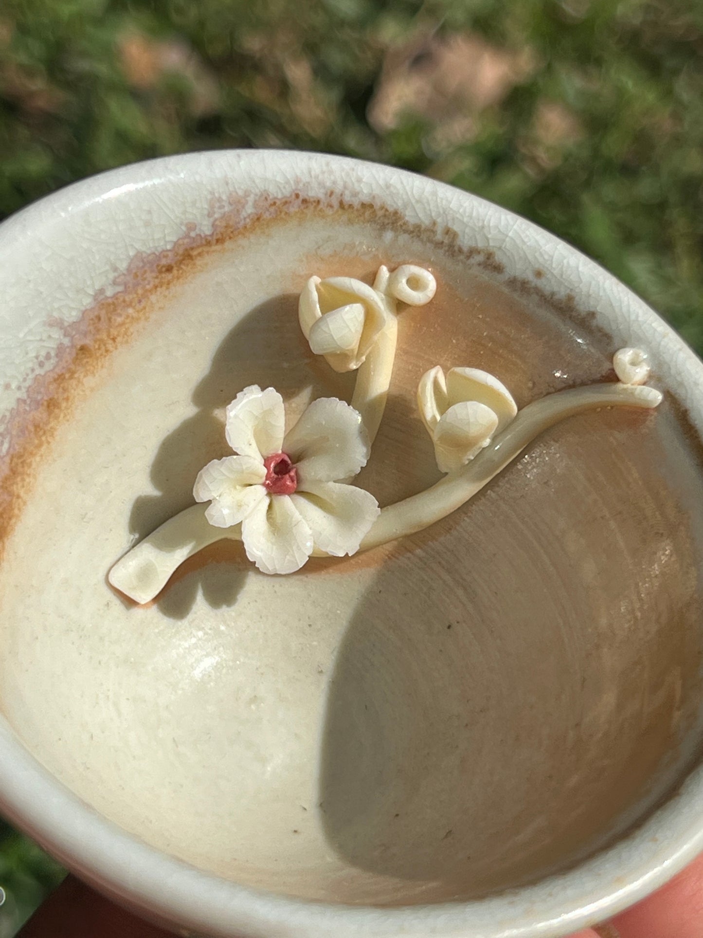 This is a woodfired pottery flower teacup