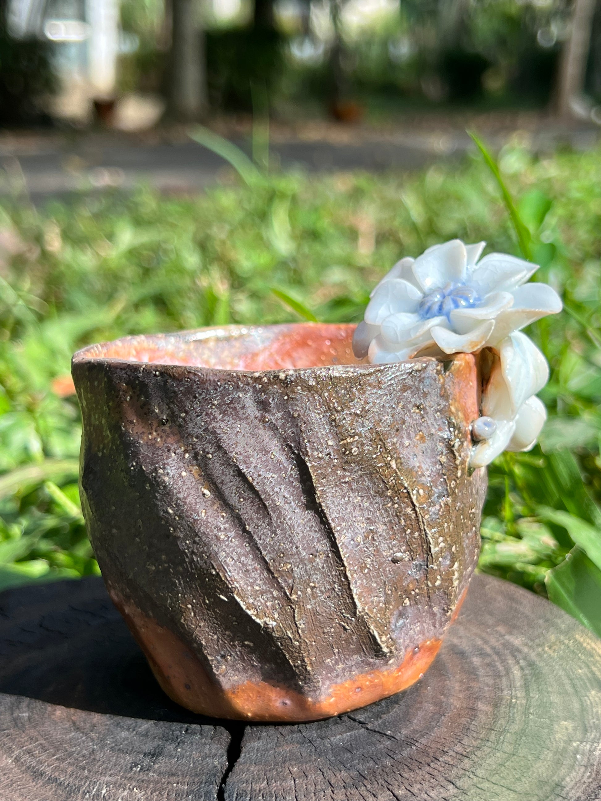 This is a woodfired pottery flower teacup