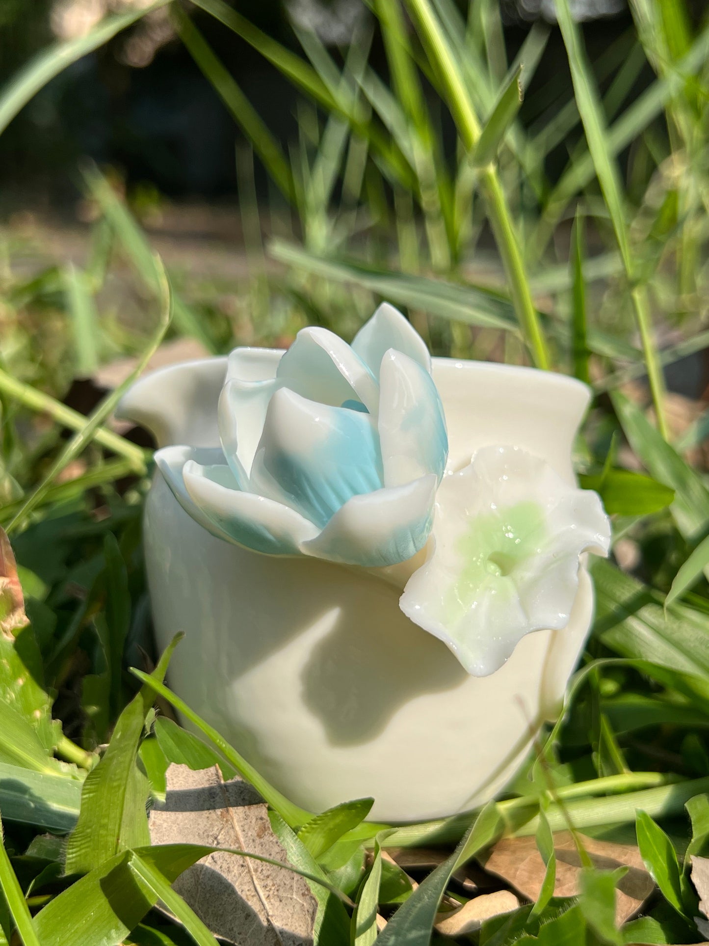 this is a woodfired white fine pottery flower teacup